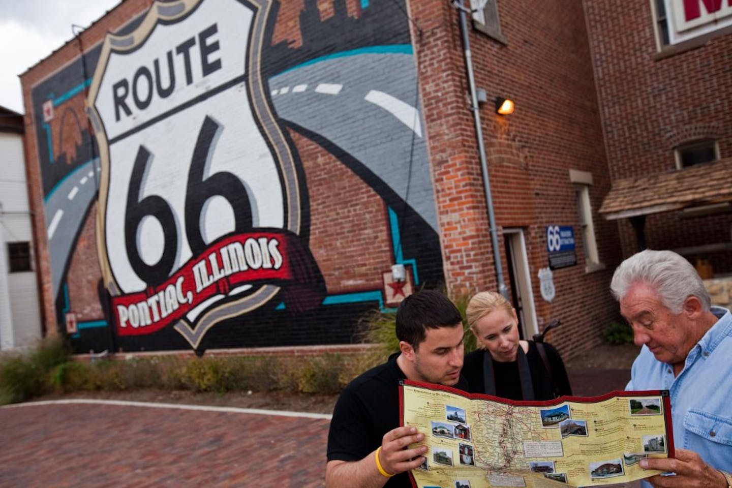 Author John Weiss, right, gave suggestions to tourists Sonny Dudas and Emilia Mattsson at the Route 66 Hall of Fame in Pontiac, Ill.