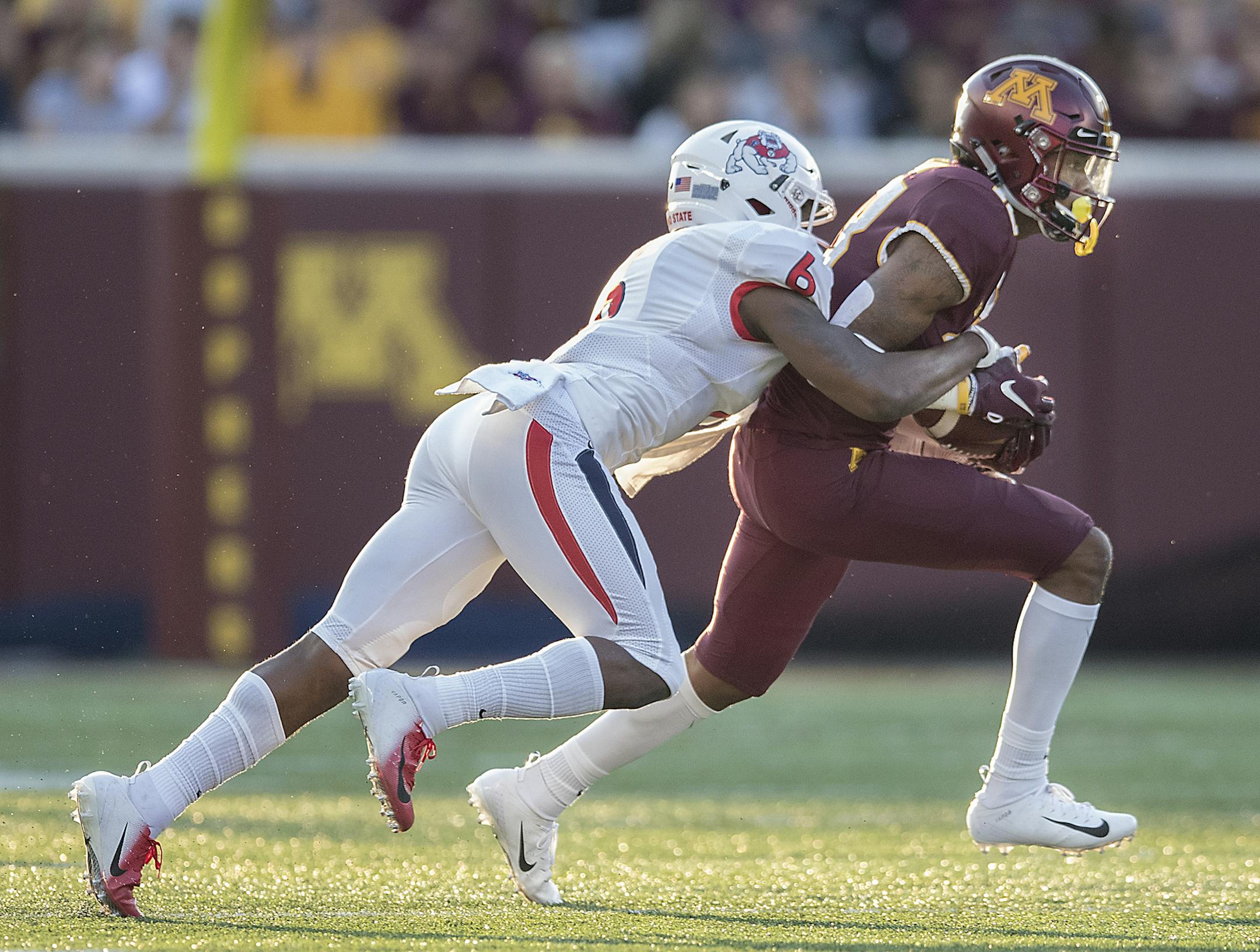 Minnesota's wide receiver Rashod Bateman carried the ball despite pressure from Fresno State's defensive back Anthoula Kelly during the first quarter as Minnesota took on Fresno State at TCF Bank Stadium, Saturday, September 8, 2018 in Minneapolis, MN. ] ELIZABETH FLORES ï liz.flores@startribune.com