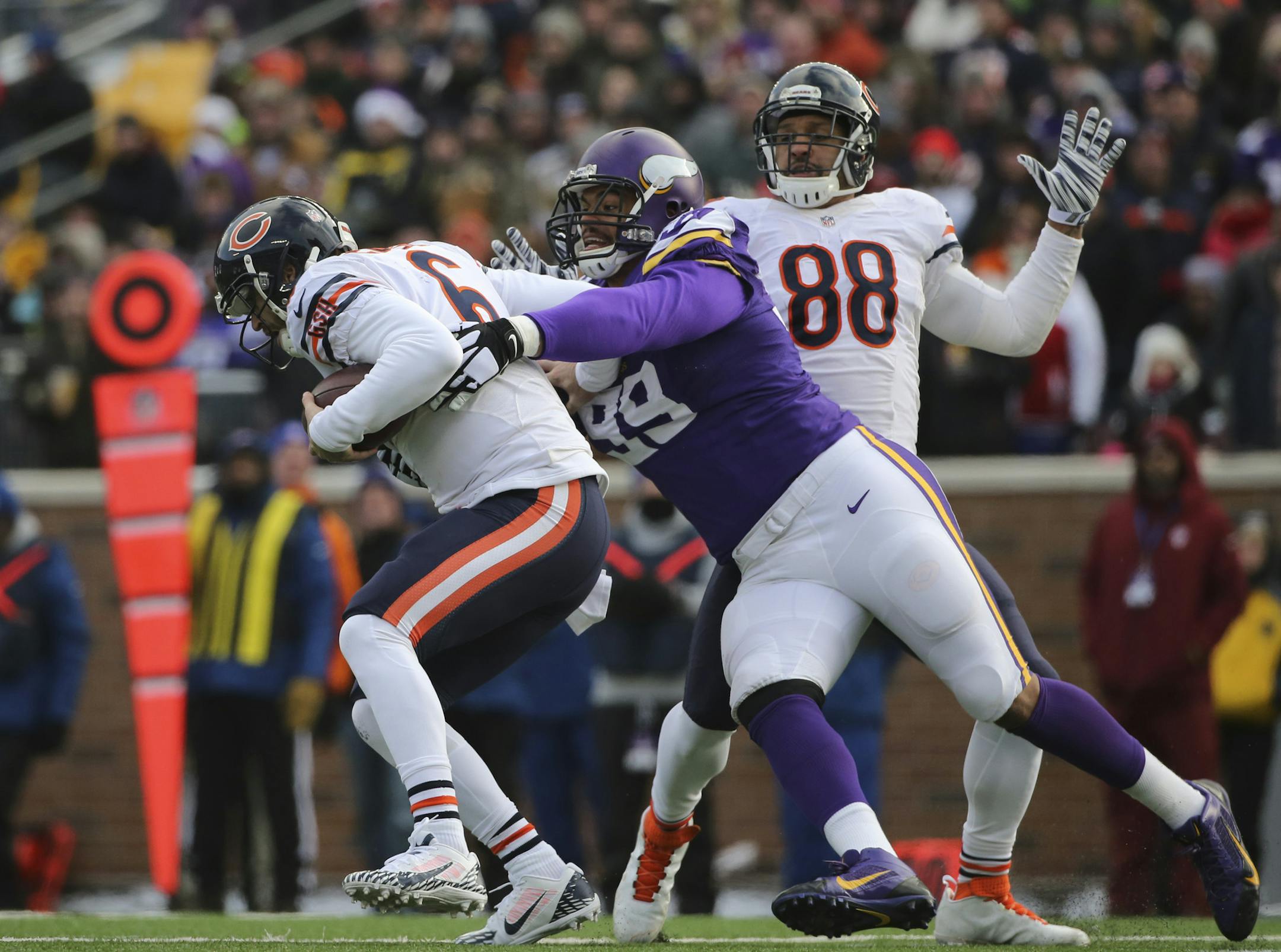 Minnesota Vikings defensive tackle Corey Wootton (99) closed in on Chicago Bears quarterback Jay Cutler (6) as he was sacked for a three yard loss in the third quarter Sunday afternoon at TCF Bank Stadium. ] JEFF WHEELER &#x201a;&#xc4;&#xa2; jeff.wheeler@startribune.com The Minnesota Vikings eeked out a 13-9 win over the Chicago Bears at TCF Bank Stadium in Minneapolis Sunday afternoon, December 28, 2014.