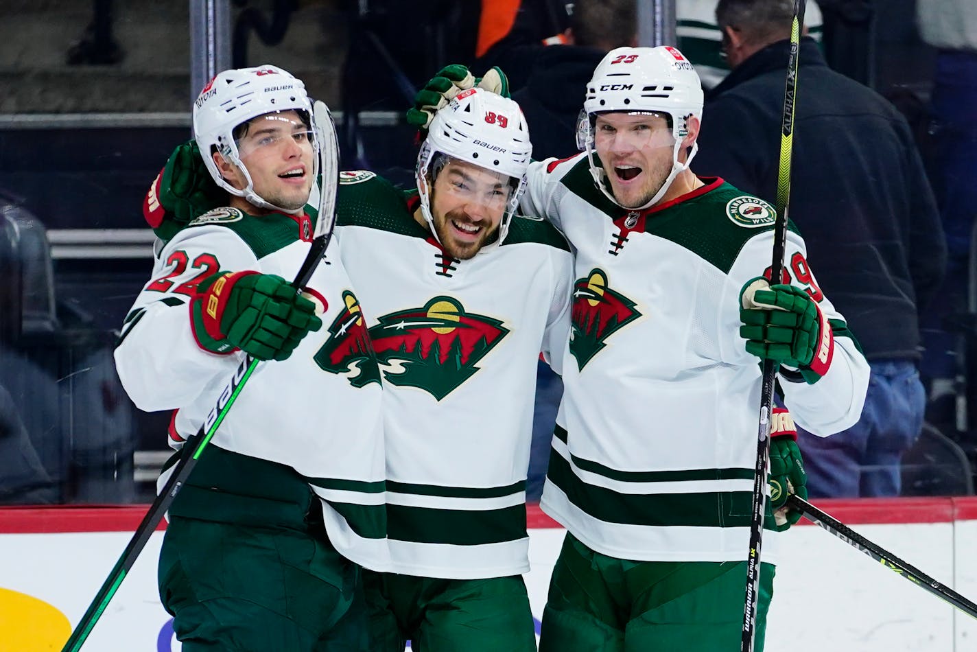 The Wild's Kevin Fiala, from left, Frederick Gaudreau and Dmitry Kulikov celebrate after a goal by Gaudreau during the first period against the Flyers,