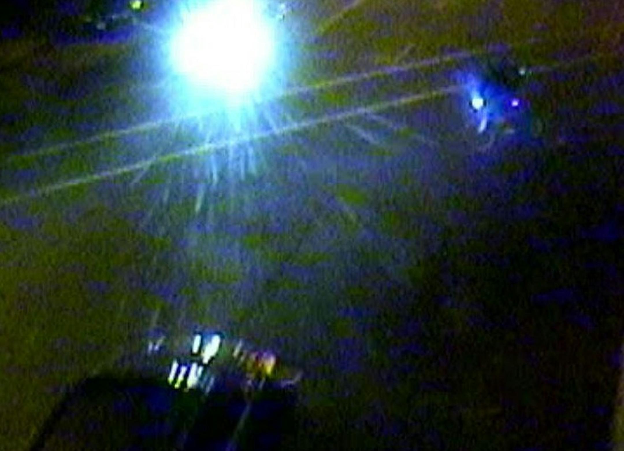 This surveillance image captured the bicyclist,at right, just before he was run over by the vehicle at the bottom of the photo.