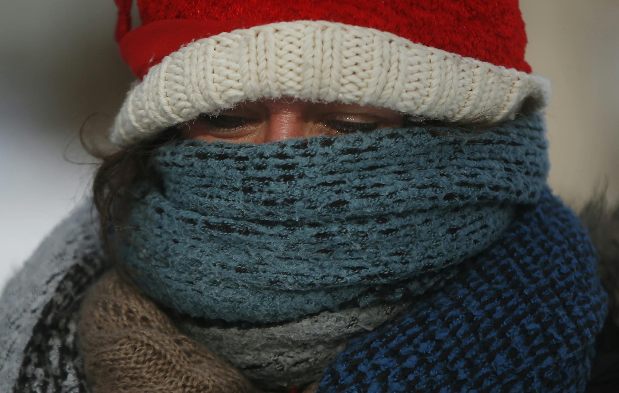 Betsy Ranum bundled up in 2014 ahead of a week of polar vortex bone-chilling weather. What will this winter bring for Minnesota? Many forecasts are already out there.