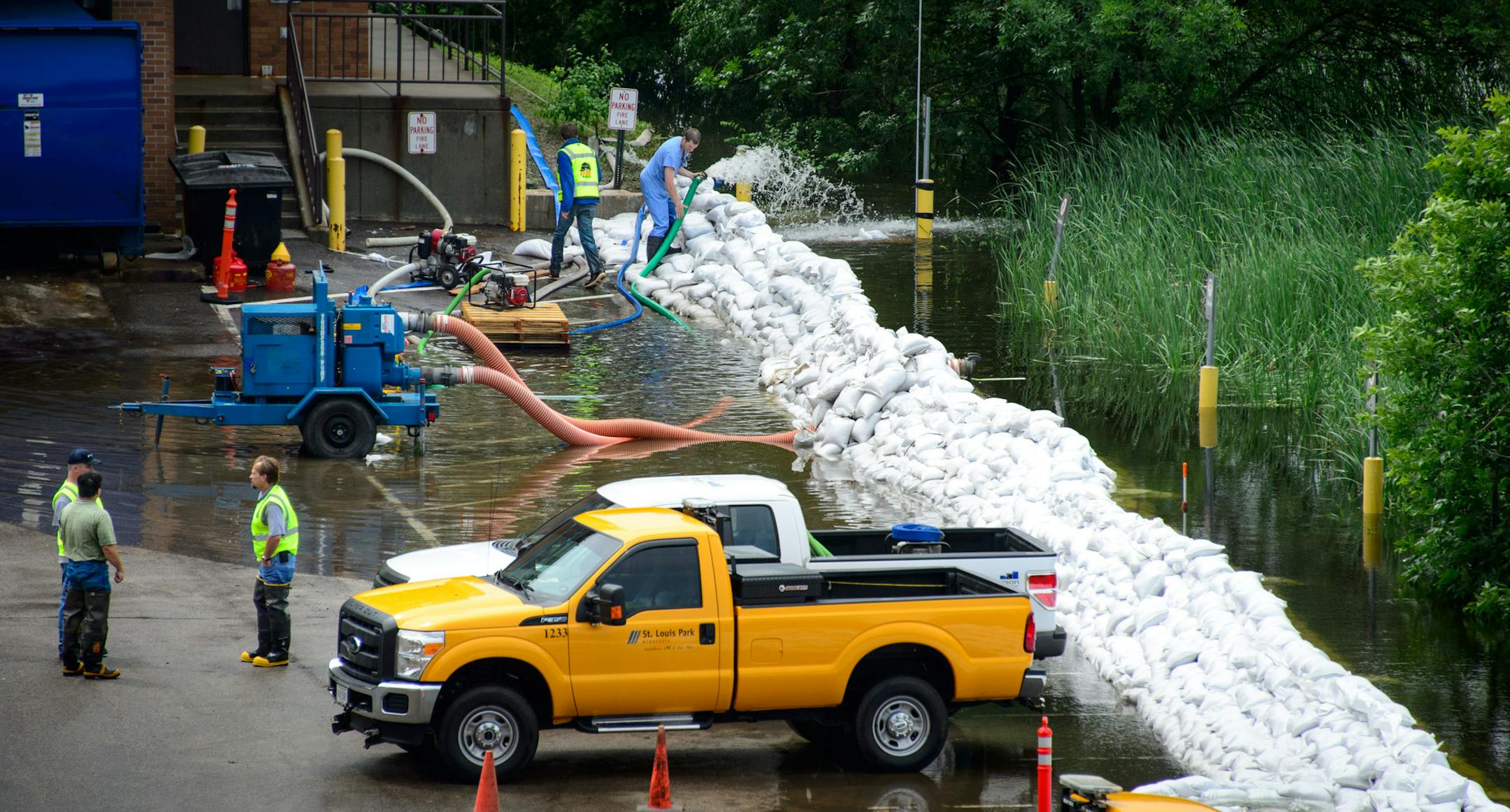 Heavy rains pushed Minnehaha Creek over its banks and workers at Park Nicollet Methodist Hospital brought in extra pumps and sandbags to keep it away from the St. Louis Park hospital. ] GLEN STUBBE * gstubbe@startribune.com Wednesday June 18, 2014