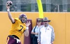 Quarterback Mitch Leidner threw a pass as coach Jerry Kill watched during practice earlier this month.