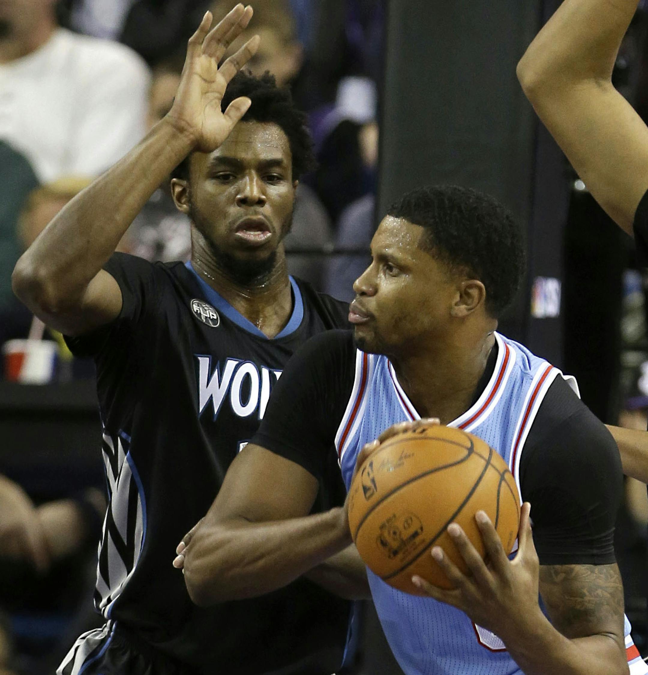 Sacramento forward Rudy Gay, center, is double-teamed by Minnesota's Andrew Wiggins, left, and Karl-Anthony Towns during the first quarter of an NBA basketball game in Sacramento, Calif., Friday, Nov. 27, 2015.(AP Photo/Rich Pedroncelli)