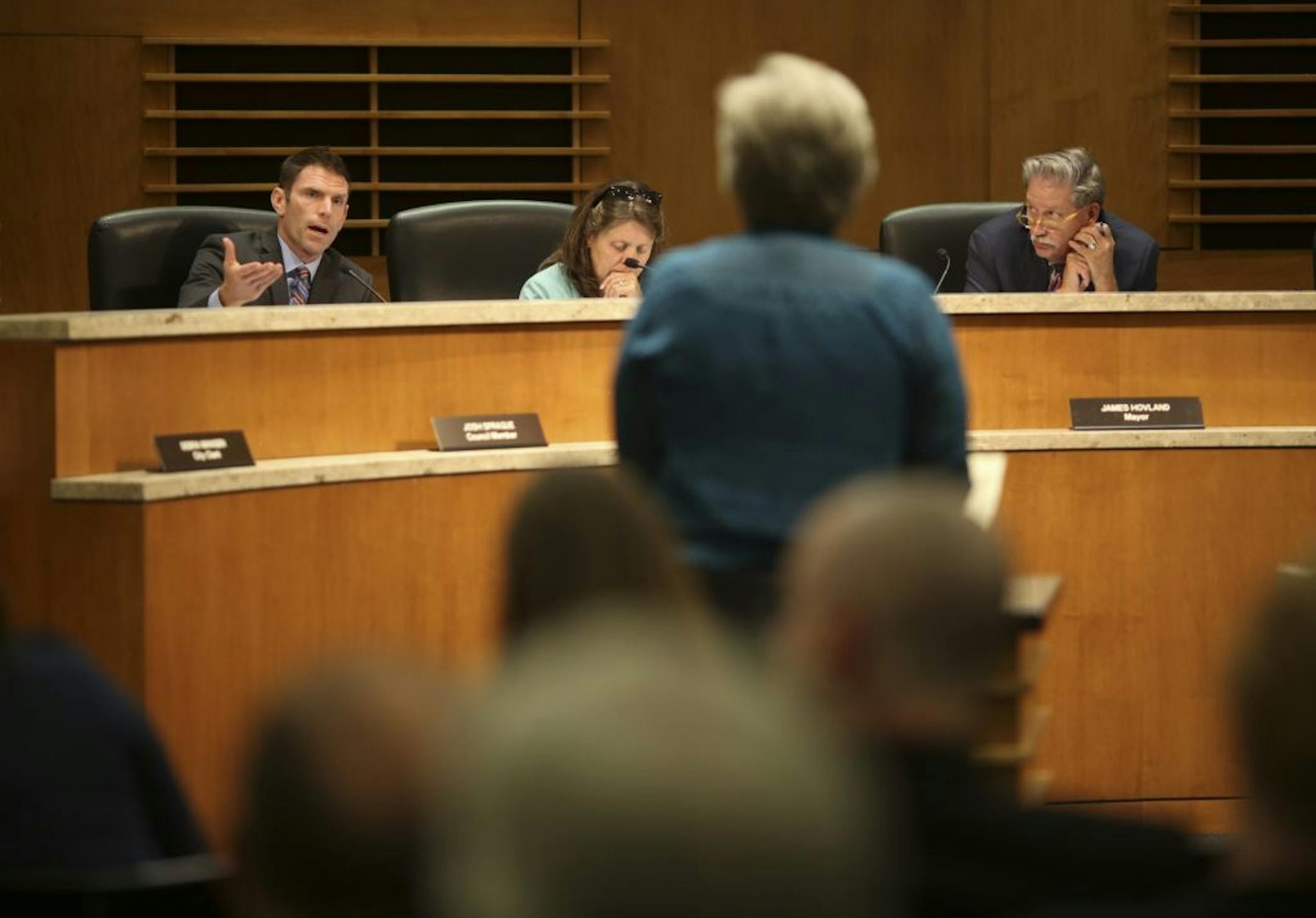 At a meeting in September, City Council Member Josh Sprague, left, asked a question of Lee Blons, Executive Director of Beacon Interfaith Housing Collaboration as the Edina City Council took up the proposed housing development. Next to Sprague is Council Member Ann Swenson; at right is Mayor James Hovland.