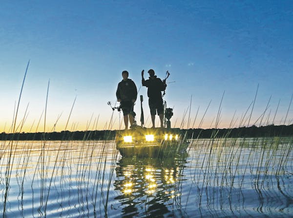 Men of the night: Bowfishermen hunt carp and other "rough'' fish long after the sun goes down, using their boat's bright lights to illuminate carp lur