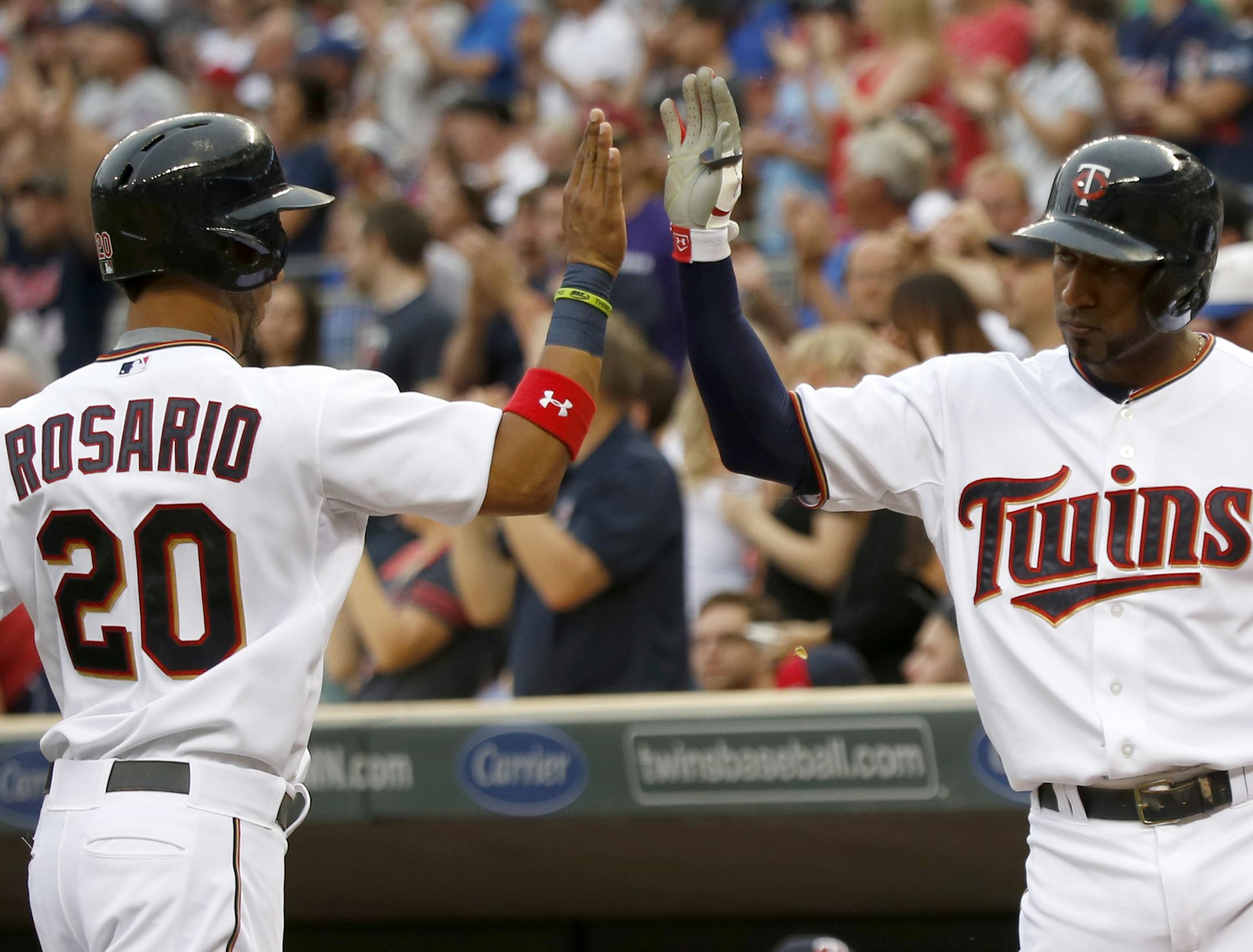 Eddie Rosario high-fived Eduardo Nunez after the rookie outfielder scored his second run of the game, following a leadoff triple.