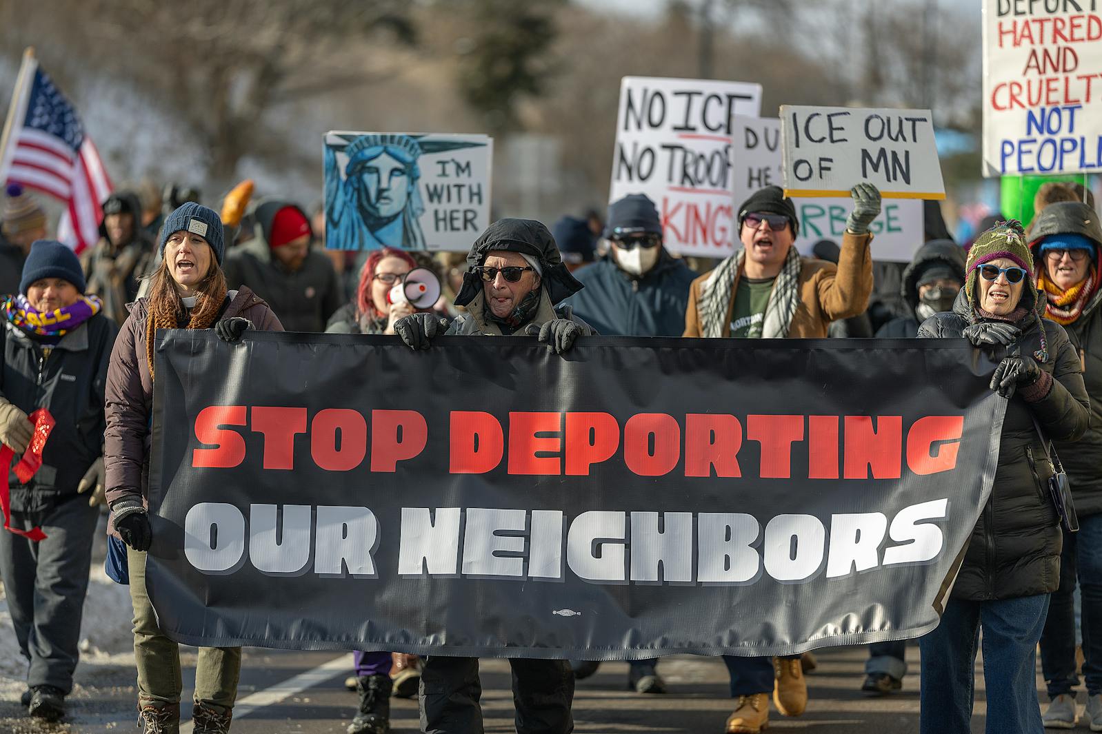 Marchers representing union workers and immigrants rights participate in a protest near Terminal 2 at Minneapolis-St. Paul International Airport on Dec. 3.