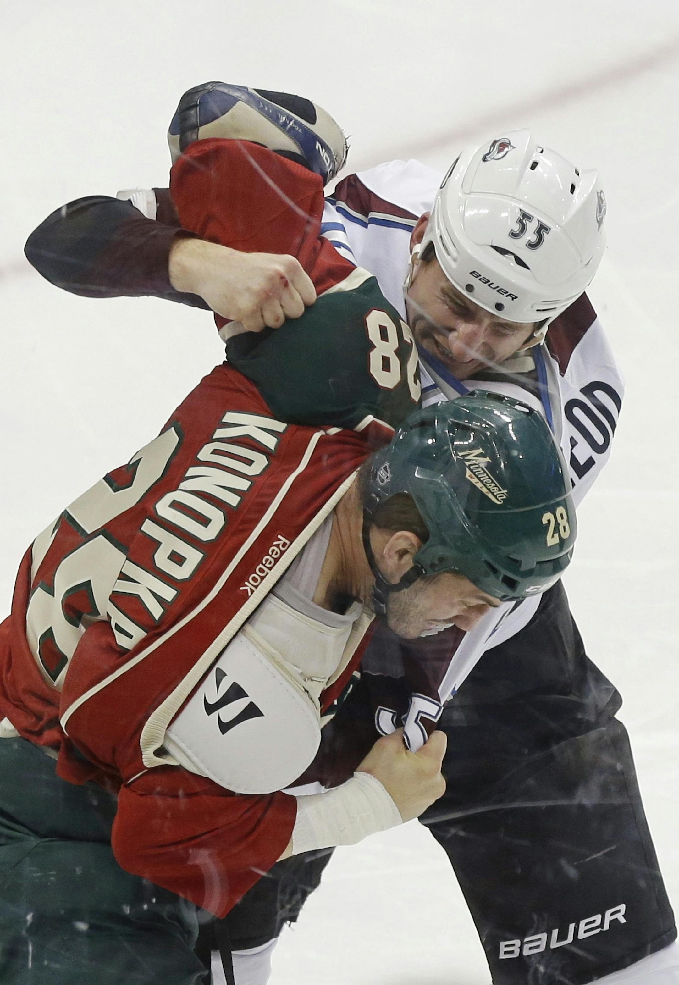 Colorado Avalanche's Cody McLeod, top, and Minnesota Wild's Zenon Konopka fight during the first period of an NHL hockey game Thursday, March 14, 2013, in St. Paul, Minn. Both received five-minute fighting penalties. (AP Photo/Jim Mone) ORG XMIT: MIN2013031518583366
