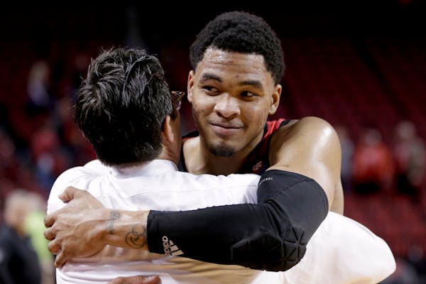 Nebraska's James Palmer Jr., right, hugs coach Tim Miles following Wednesday's game.