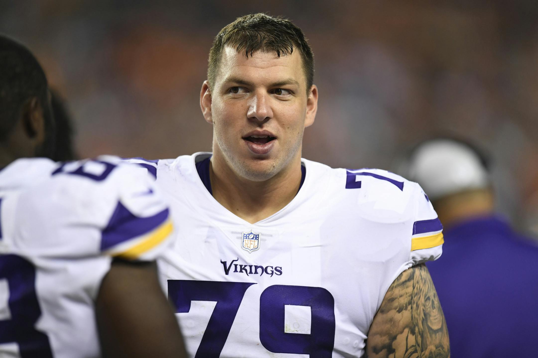 Minnesota Vikings guard Tom Compton on the sidelines in the second half of an NFL football game against the Denver Broncos Saturday, Aug. 11, 2018, in Denver. (AP Photo/Mark Reis)