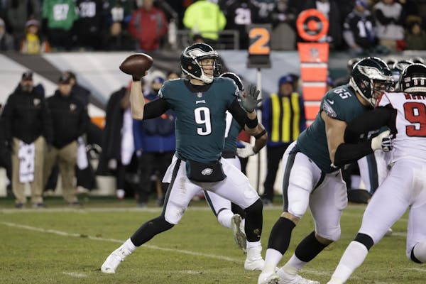 Philadelphia Eagles' Nick Foles in action during the first half of an NFL divisional playoff football game against the Atlanta Falcons, Saturday, Jan.