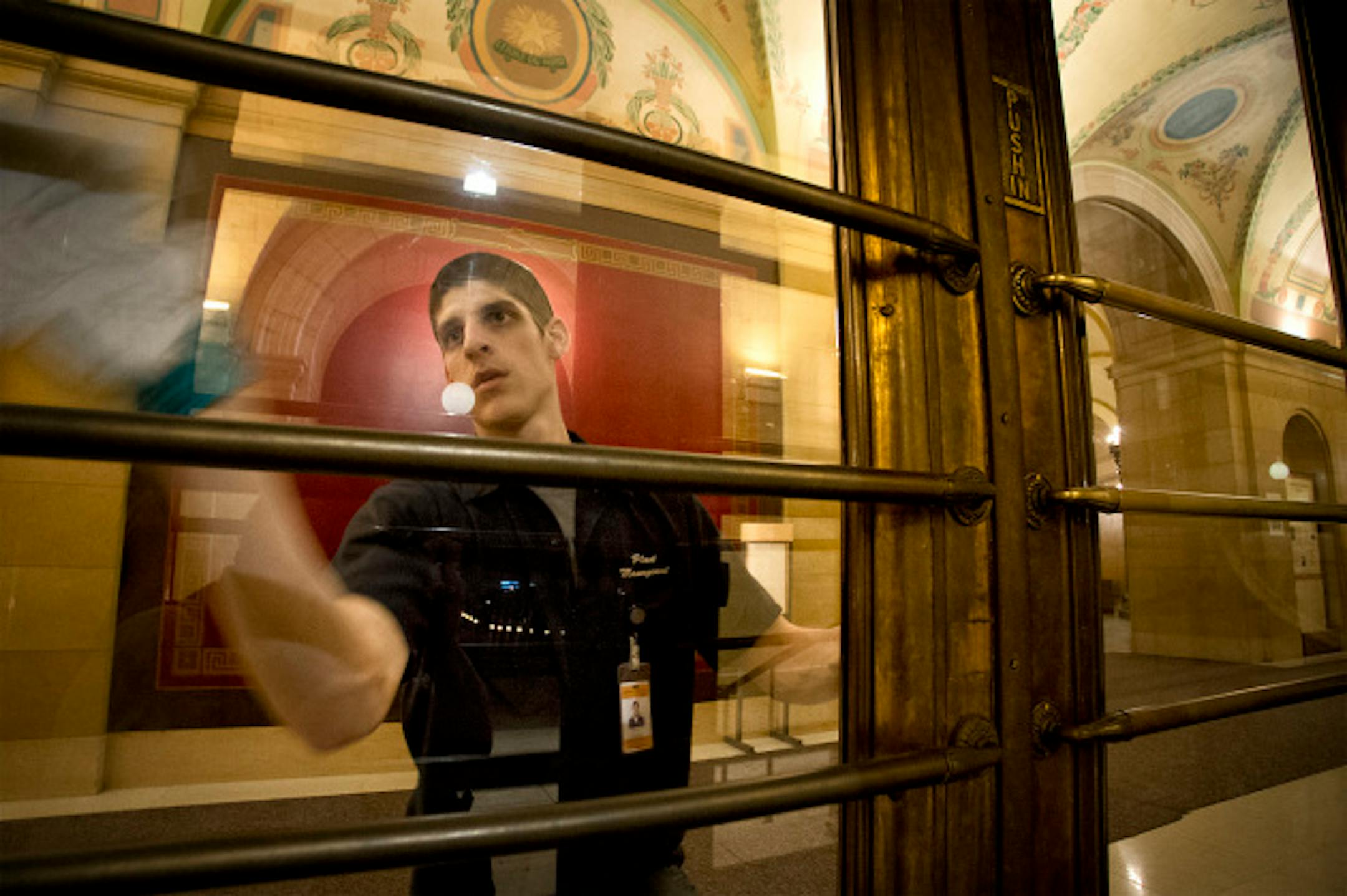 Charles Krueger made sure the glass doors to the Capitol were fingerprint-free late Monday night while legislators made their final arguments, Monday, May 20, 2013  ]   GLEN STUBBE * gstubbe@startribune.com