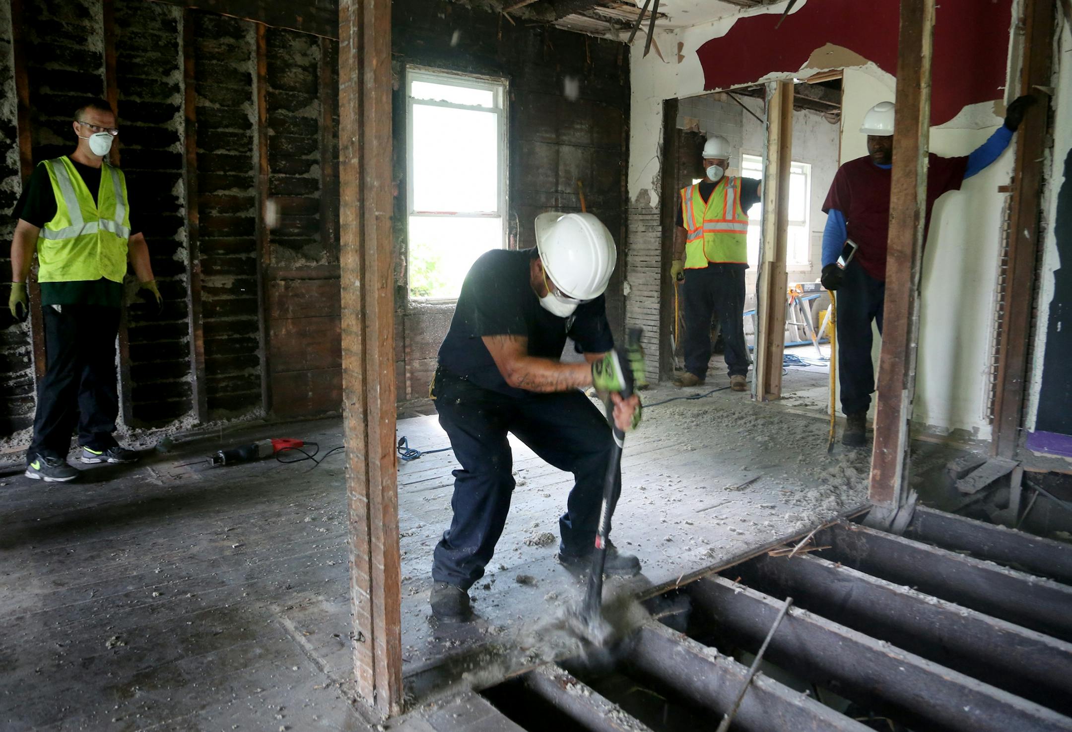 Workers for Better Homes Minnesota, a non-profits that assists men in the community in gaining employment while helping protecting the environment, worked to disassemble a house slated for with most of the materials will be reused and seen Tuesday, July 18, 2017, in Roseville, MN.