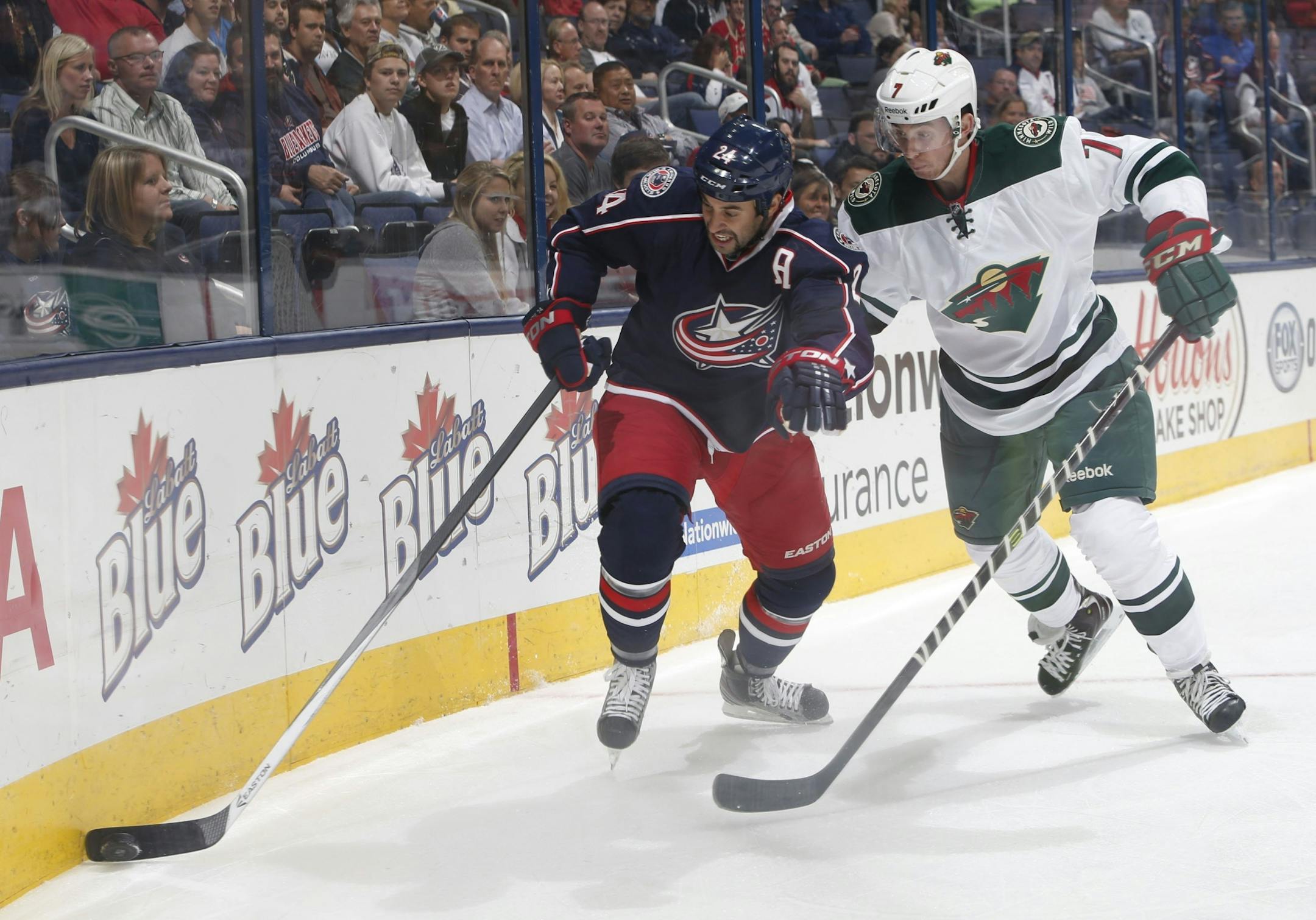 Wild defenseman Jon Blum (right)