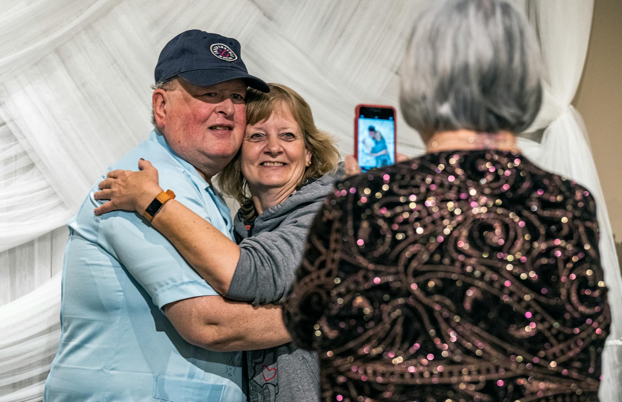 Tairie Starr takes a picture of Tim and Pam Jost who got married at the Chapel of Love 20 years ago on Valentine's Day.
