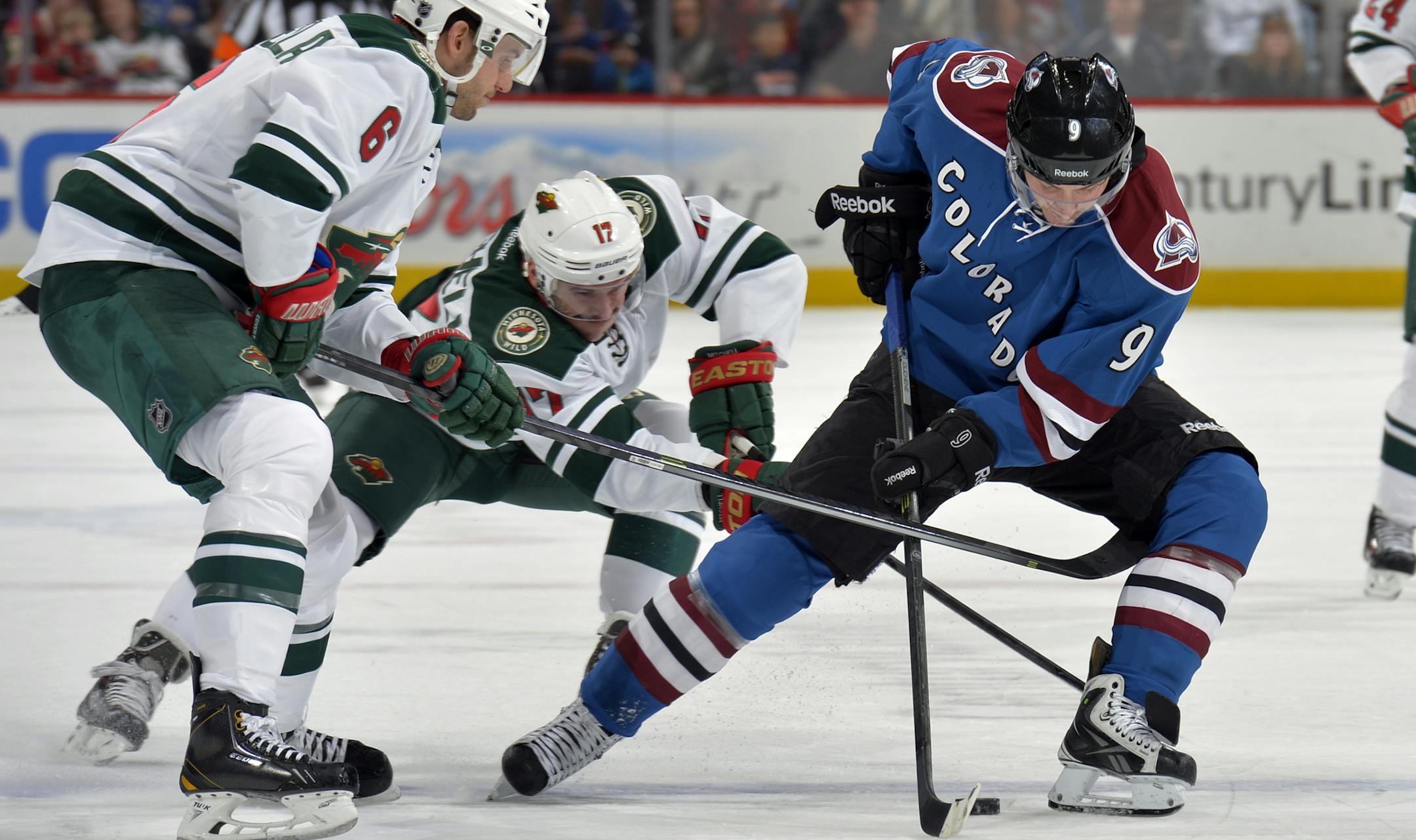 Colorado Avalanche center Matt Duchene (9) skates against Minnesota Wild center Torrey Mitchell (17) and Marco Scandella (6) during the first period of an NHL hockey game on Saturday, Nov. 30, 2013, in Denver. (AP Photo/Jack Dempsey)