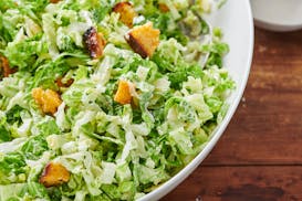 FILE- Top this Caesar salad with some sliced chicken, a piece of grilled salmon or tuna steak, or some poached or grilled shrimp for a restaurant-y en