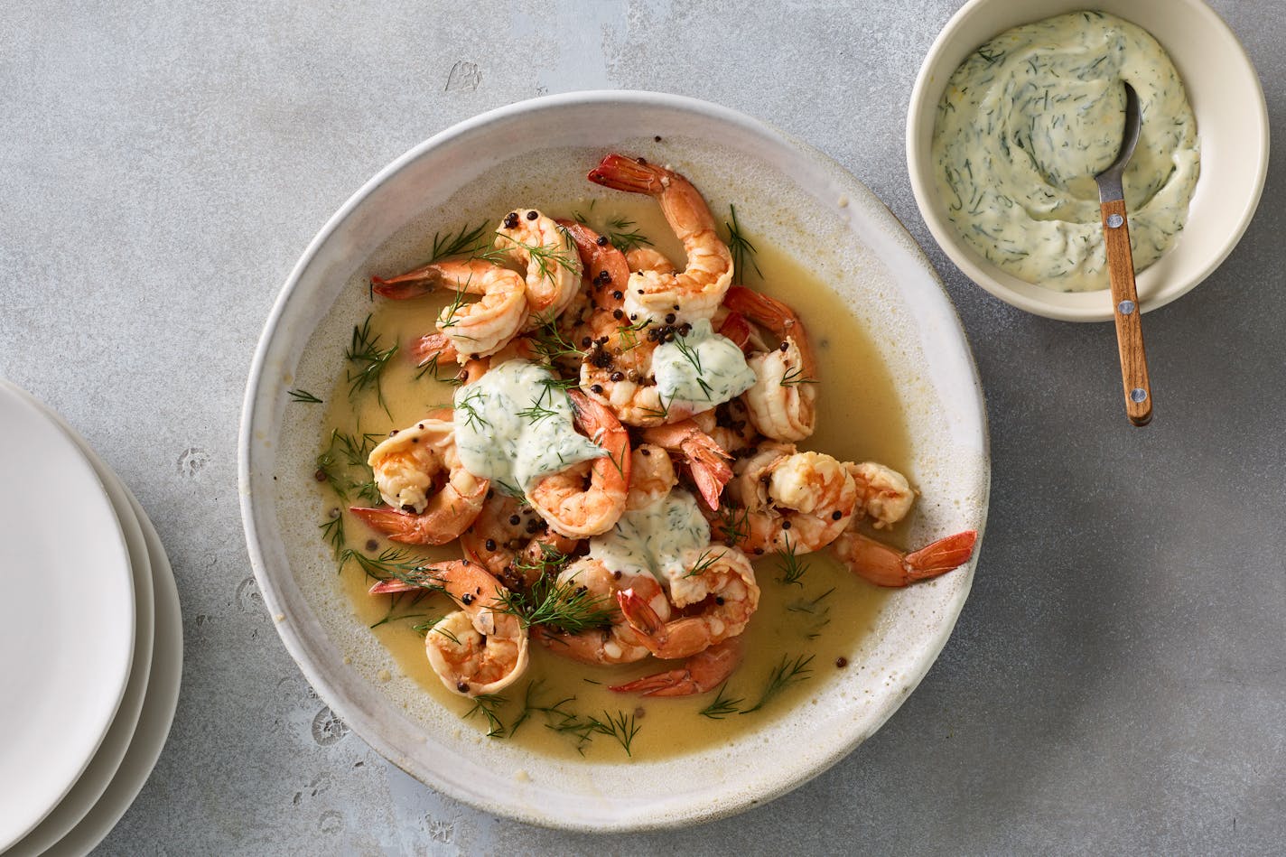 Butter-poached shrimp with dill mayonnaise in New York, March 8, 2023. Nix the garlic for coriander seeds and a dollop of dill-speckled mayo for a subtle, speedy dish that's all about the shrimp. Food styled by Barrett Washburne. (James Ransom/The New York Times)