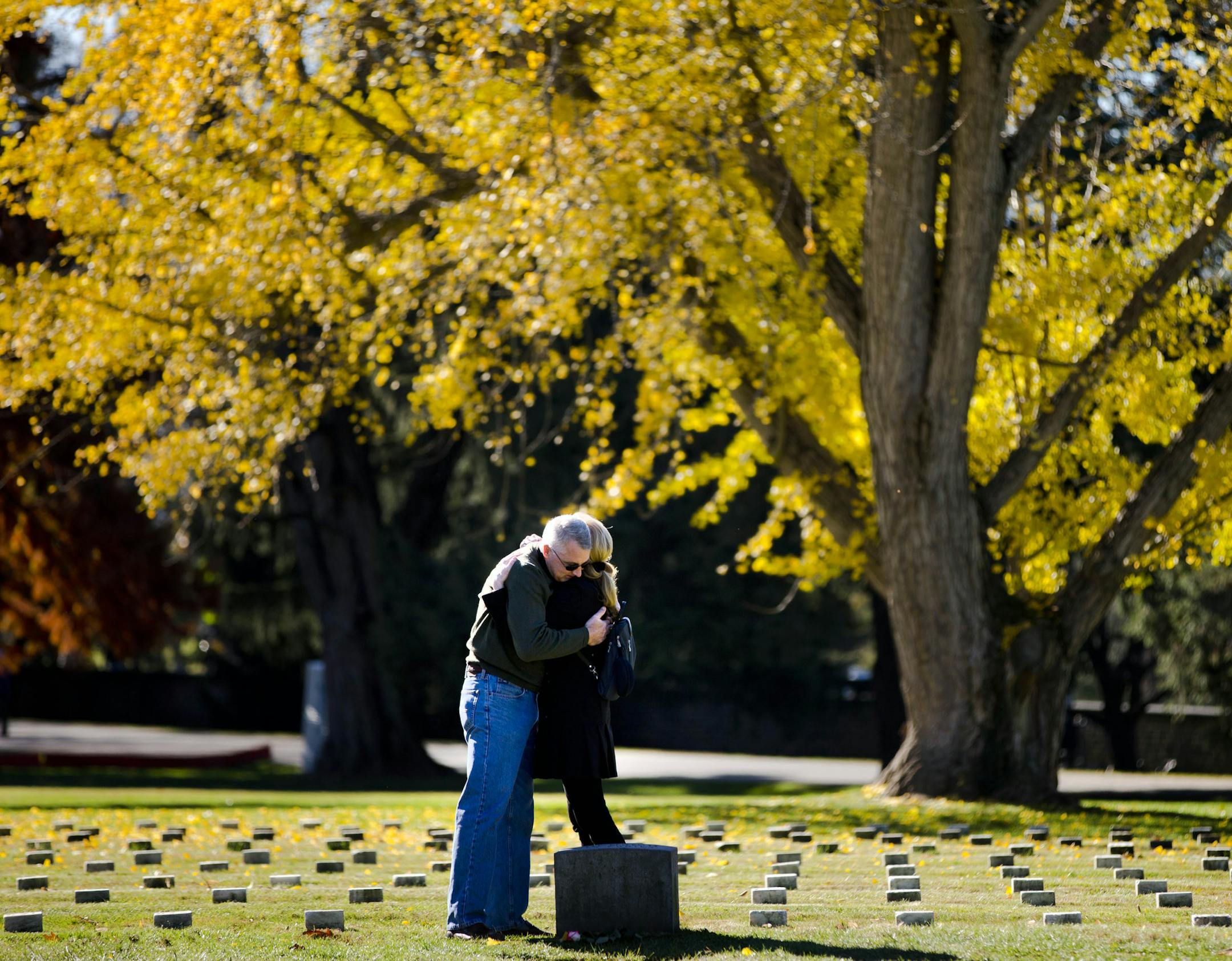 Tom Stack and Jill MacKenzie pay their respects at a stone marking the resting place of some of the unknown dead from the battle of Gettysburg, at Soldiers' National Cemetery Monday, Nov. 18, 2013, in Gettysburg, Pa. Nov. 19th marks the 150th anniversary of President Abraham Lincoln's short speech that has gone on to symbolize his presidency and explain the sacrifices made by Union and Confederate forces during the U.S. Civil War. (AP Photo/Matt Rourke)