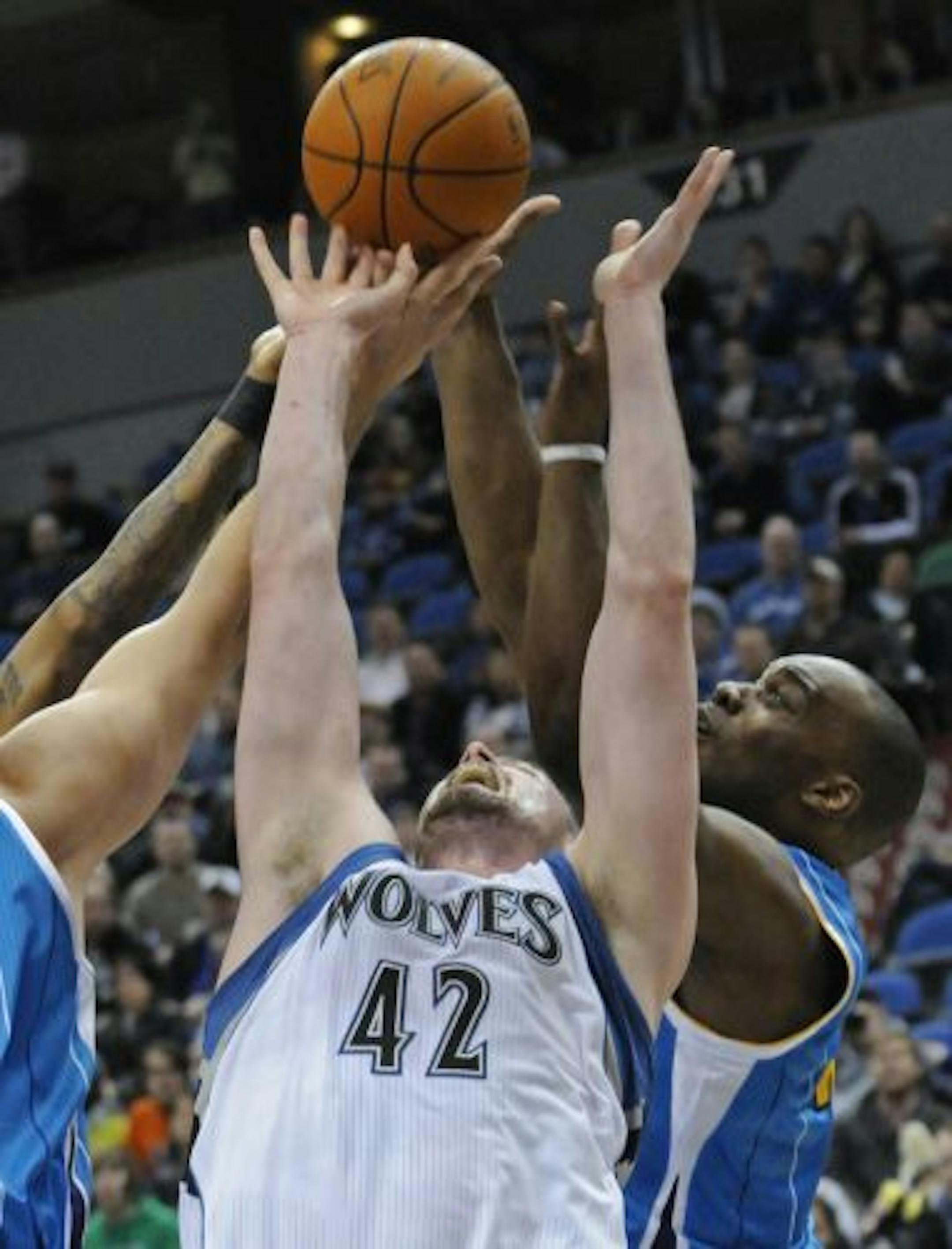 Minnesota Timberwolves' Kevin Love (42) and new New Orleans Hornets player Carl Landry, right, battle for the rebound during the first half of an NBA basketball game Friday, Feb. 25, 2011, in Minneapolis.