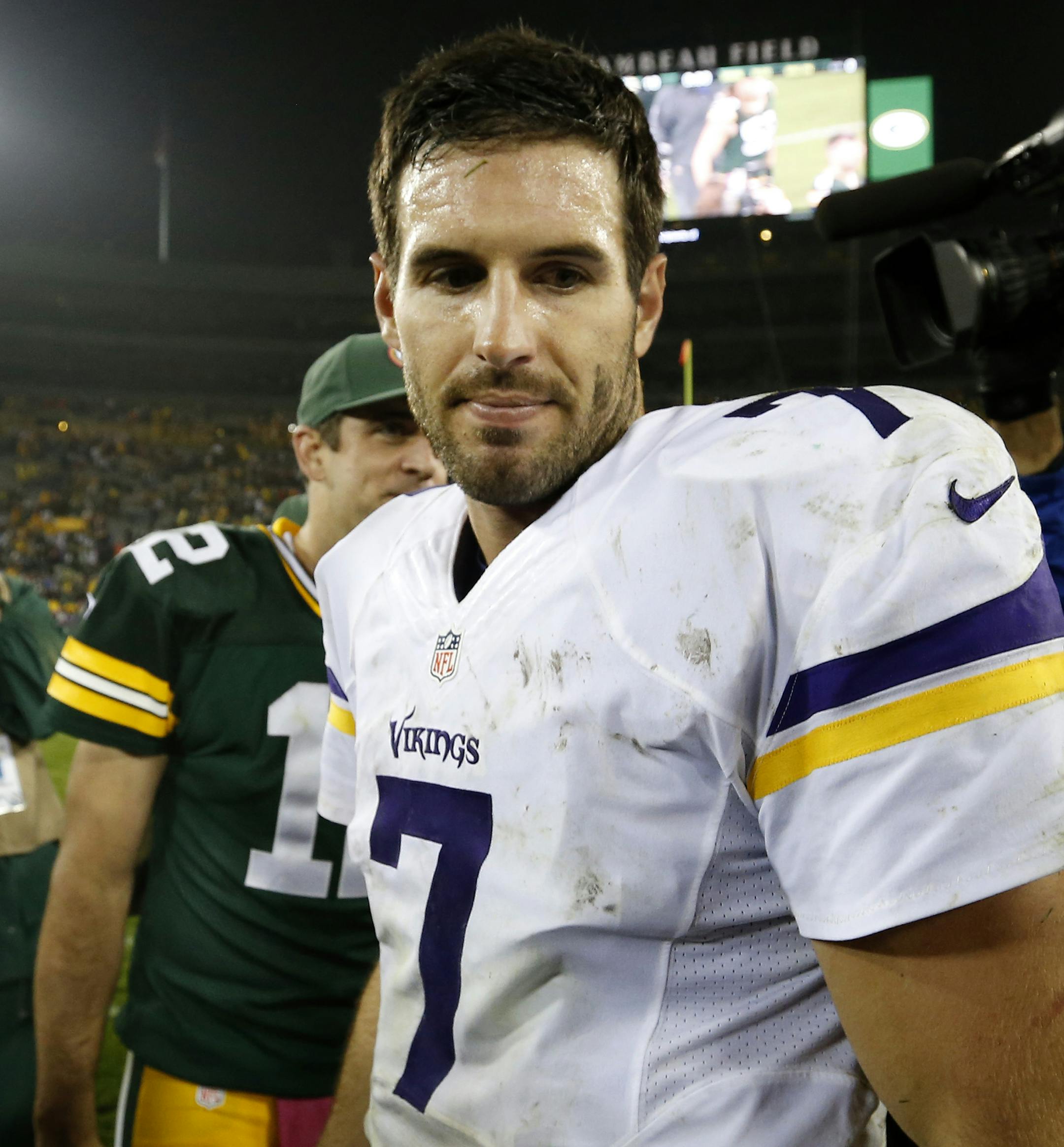 Vikings quarterback Christian Ponder (7) walked away from Packers quarterback Aaron Rodgers (12) after shaking hands at the end of the game. Green Bay beat Minnesota by a final score of 42-10. ] CARLOS GONZALEZ cgonzalez@startribune.com - October 2, 2014 , Green Bay, WI NFL, Lambeau Field, Minnesota Vikings vs. Green bay Packers