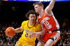 Minnesota guard Sean Sutherlin (24) tries to move around Illinois guard Luke Goode (10) during the first half of an NCAA college basketball game Tuesd