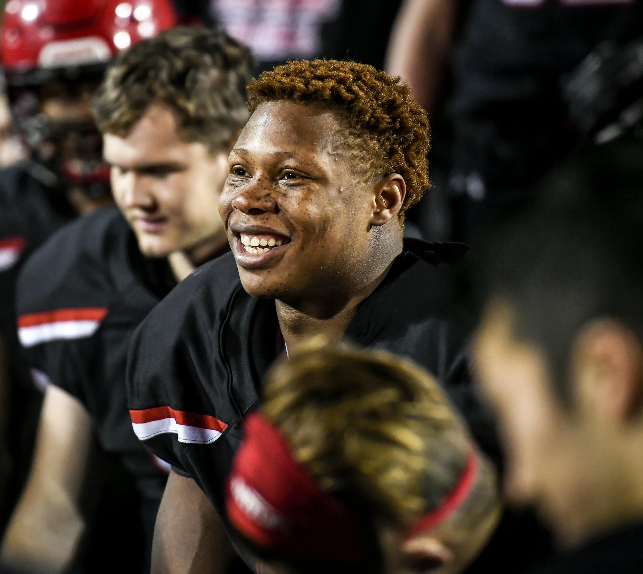 Justice Sullivan, 16, a sophomore at Eden Prairie, was all smiles in the team huddle after defeating Maple Grove 38-14 at Eden Prairie High School on Friday, Sept. 28, 2018. Justice was adopted by Jake and Janel Sullivan when he was about eight years old from Ghana. He was initially thought to be five because of malnourishment. ] Aaron Lavinsky ¥ aaron.lavinsky@startribune.com Minnesota sports fans remember Jake Sullivan as the sharpshooting high school star and local kid who helped make Io