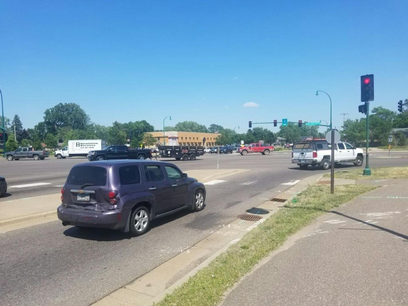 Motorists make a right turn at the intersection of Bass Lake Road and Bottineau Boulevard in Crystal where the right turn lane is separated from through traffic by a concrete median and controled by a stoplight.