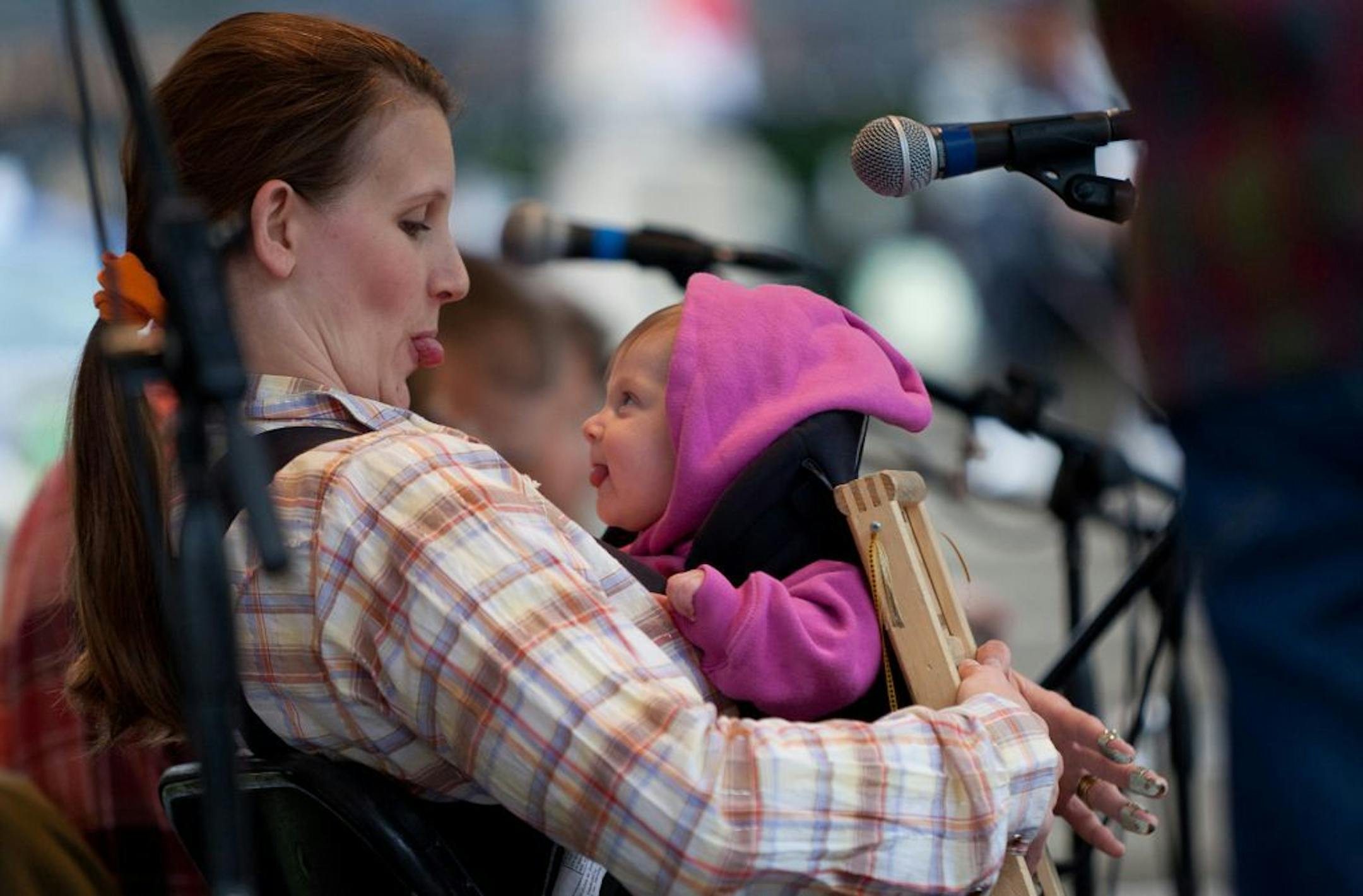 Kim Roe, of the old timey band Roe Family Singers, with her 4-month-old daughter Onnee during a Friday evening performance at Peavey Plaza on June 10, 2011.