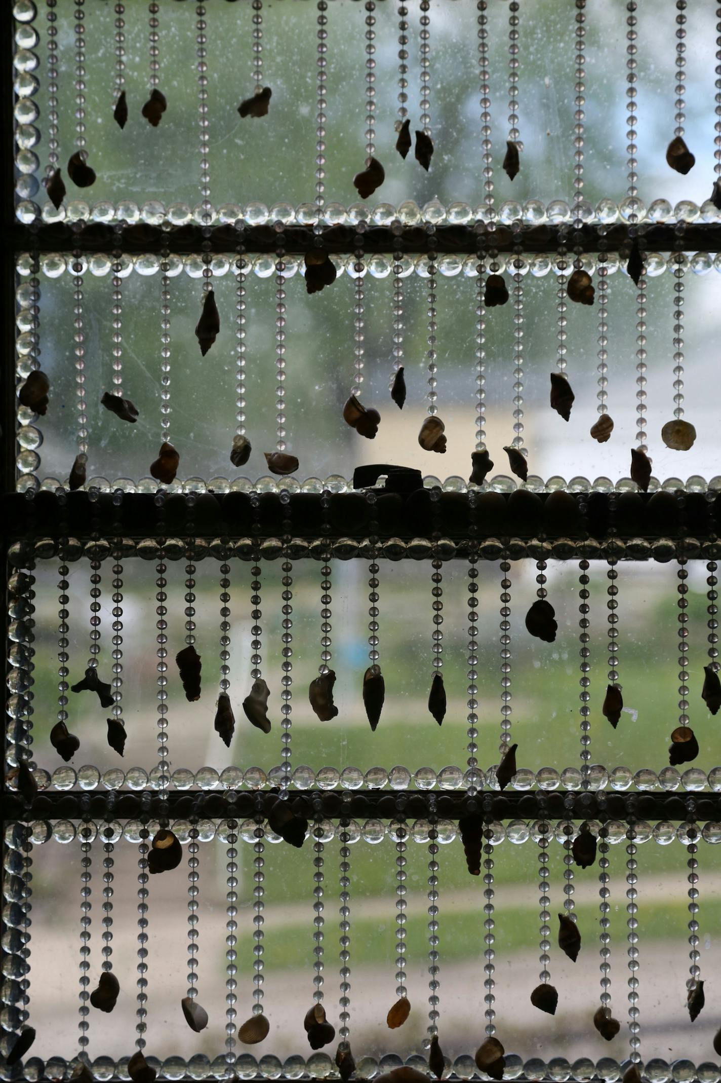 Sea shells on glass beads decorate Lauri Svedberg's kitchen window. ] (KYNDELL HARKNESS/STAR TRIBUNE) kyndell.harkness@startribune.com Lauri Svedberg's home she is putting on the market in Minneapolis Min., Friday, May 8, 2015.