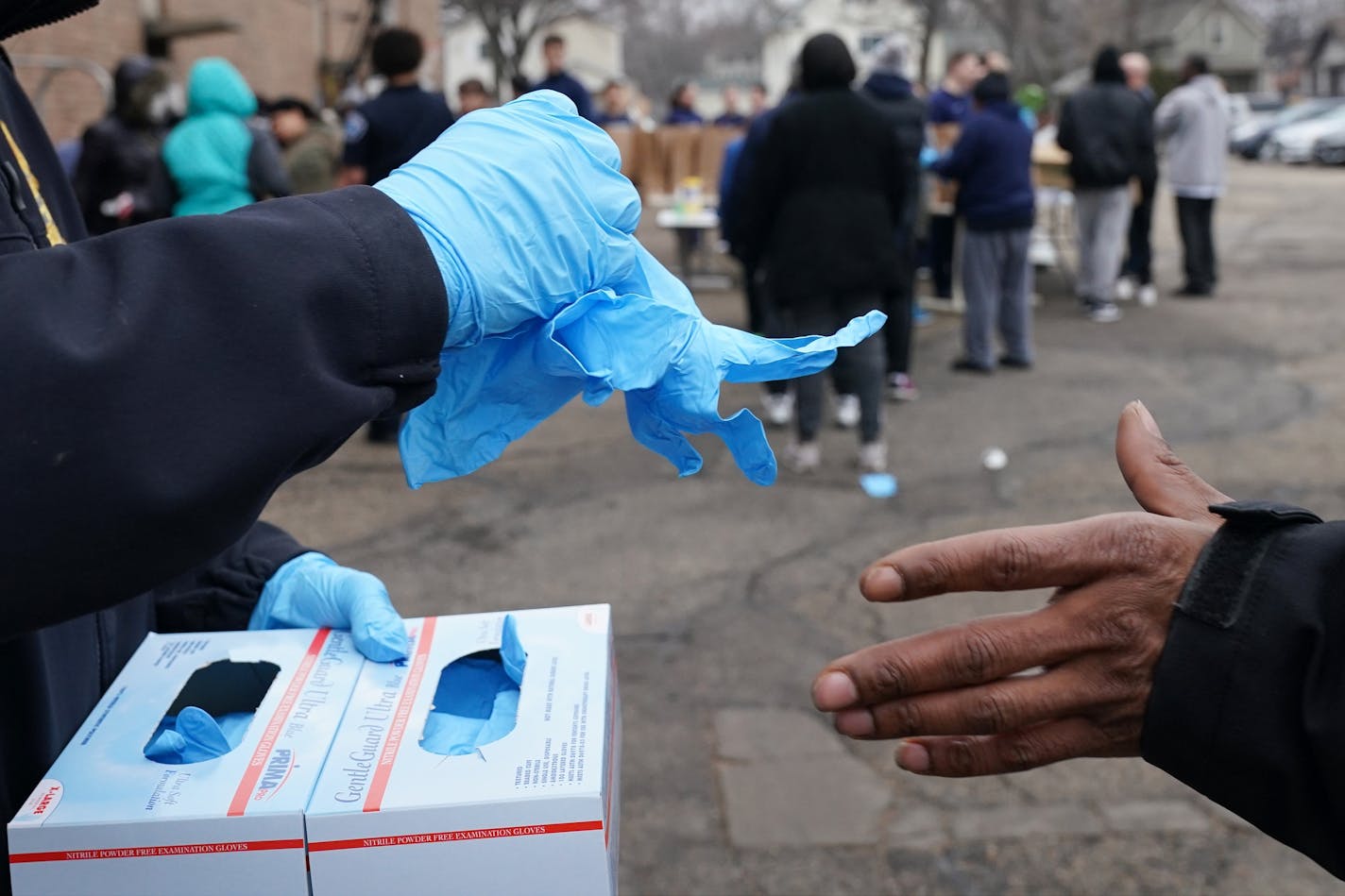 Gloves were provided for anyone who wanted them during the free grocery giveaway event Wednesday at the Minneapolis Police Activities League.