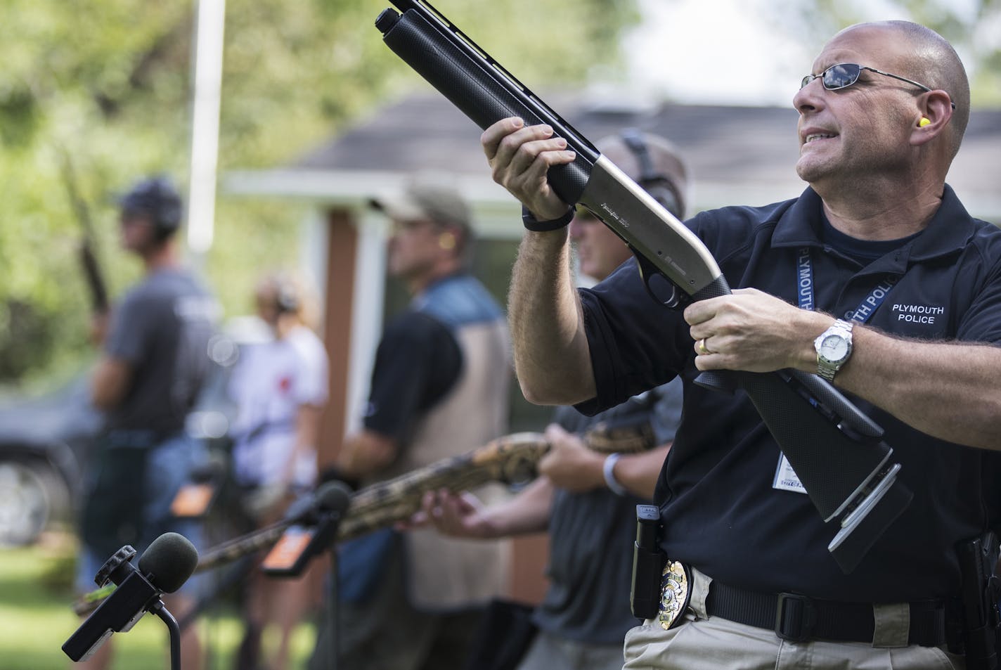 Plymouth Police chief Mike Goldstein grimaces after missing a shot during a friendly trap shooting competition with the Wayzata High School Trap Team. ] (Leila Navidi/Star Tribune) leila.navidi@startribune.com BACKGROUND INFORMATION: The Wayzata High School Trap Team paired up with the Plymouth Police on Tuesday, August 9, 2016 for some friendly trap shooting at the Plymouth Gun Club. In Minnesota, trap shooting is the fastest growing high school sport, with nearly 9,000 students participating i