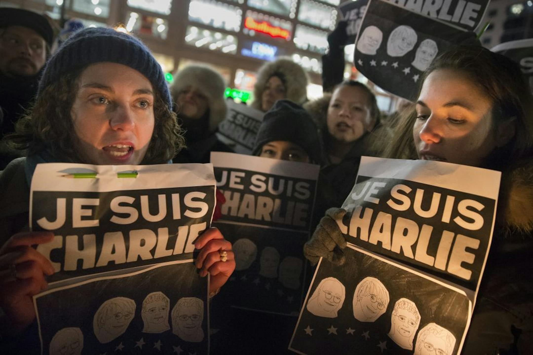 Mourners hold signs that read "I AM CHARLIE" during a rally in support of Charlie Hebdo, a French satirical weekly newspaper that fell victim to an terrorist attack, Wednesday, Jan. 7, 2015, at Union Square in New York. French officials say 12 people were killed when masked gunmen stormed the Paris offices of the periodical that had caricatured the Prophet Muhammad.
