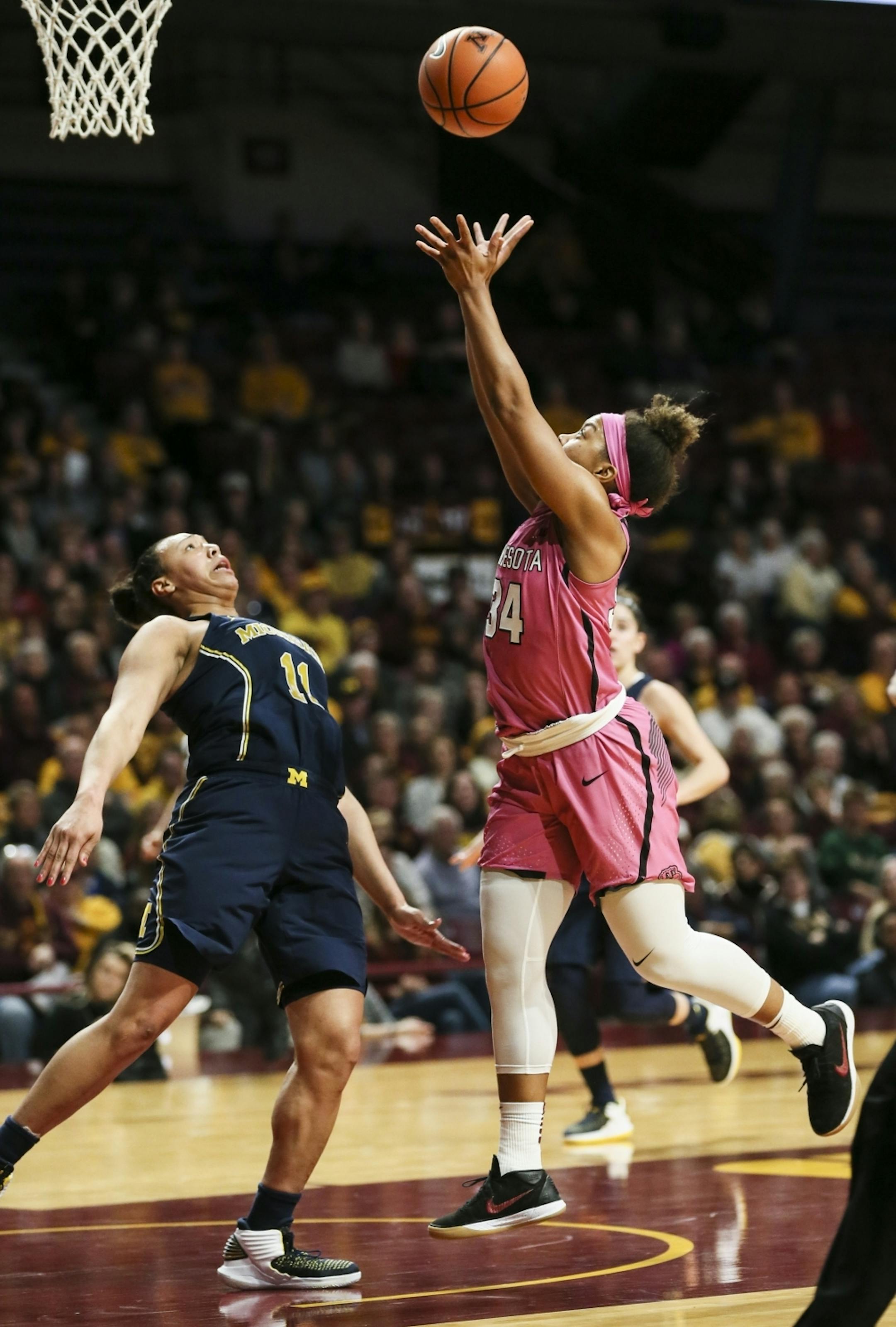 Minnesota Golden Gophers guard Gadiva Hubbard (34) jumped for a shot against Michigan Wolverines Jillian Dunston (11) in the first half.