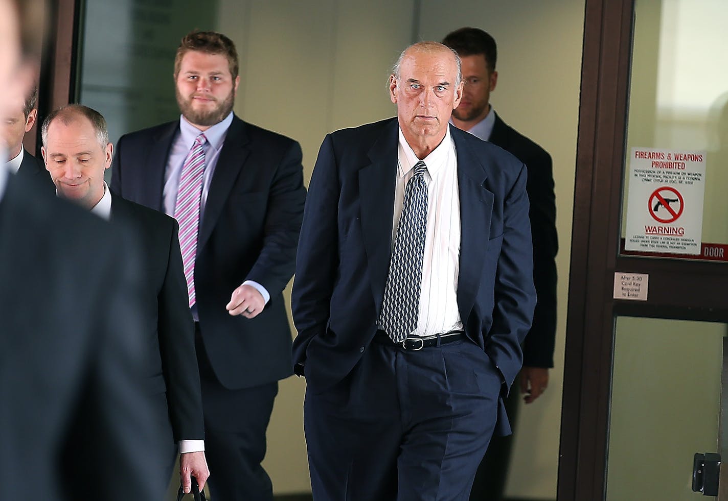 Former Gov. Jesse Ventura made his way out of the Warren E. Burger Federal Building during the first day of his defamation trial, Tuesday, July 8, 2014 in St. Paul.