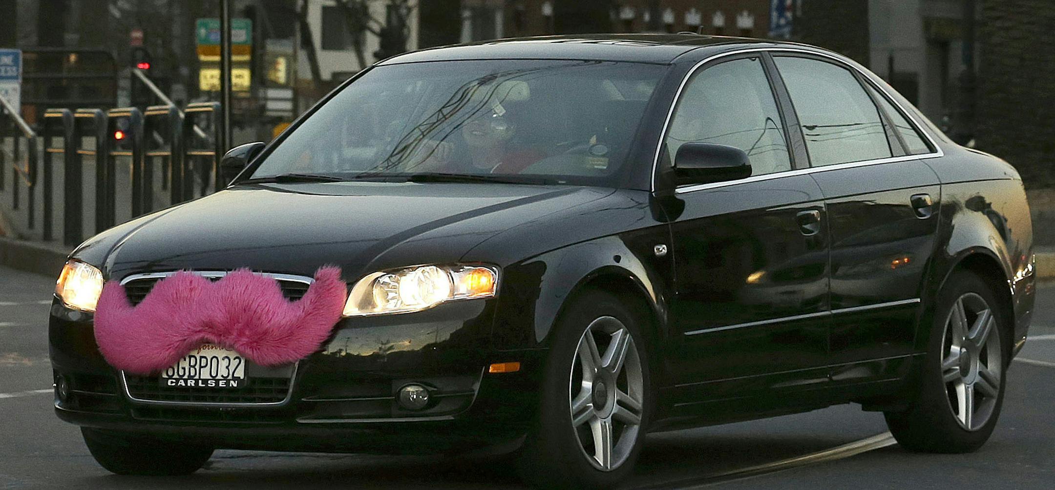 FILE - In this Jan. 17, 2013, file photo, a Lyft car crosses Market Street in San Francisco. Utah officials are warning smartphone users to check their insurance policies before tapping into ridesharing apps. The Utah Insurance Department says drivers for companies such as Uber and Lyft, who use their own vehicles, should also consult whether they would be covered in an accident. (AP Photo/Jeff Chiu, File) ORG XMIT: MIN2014060517580716