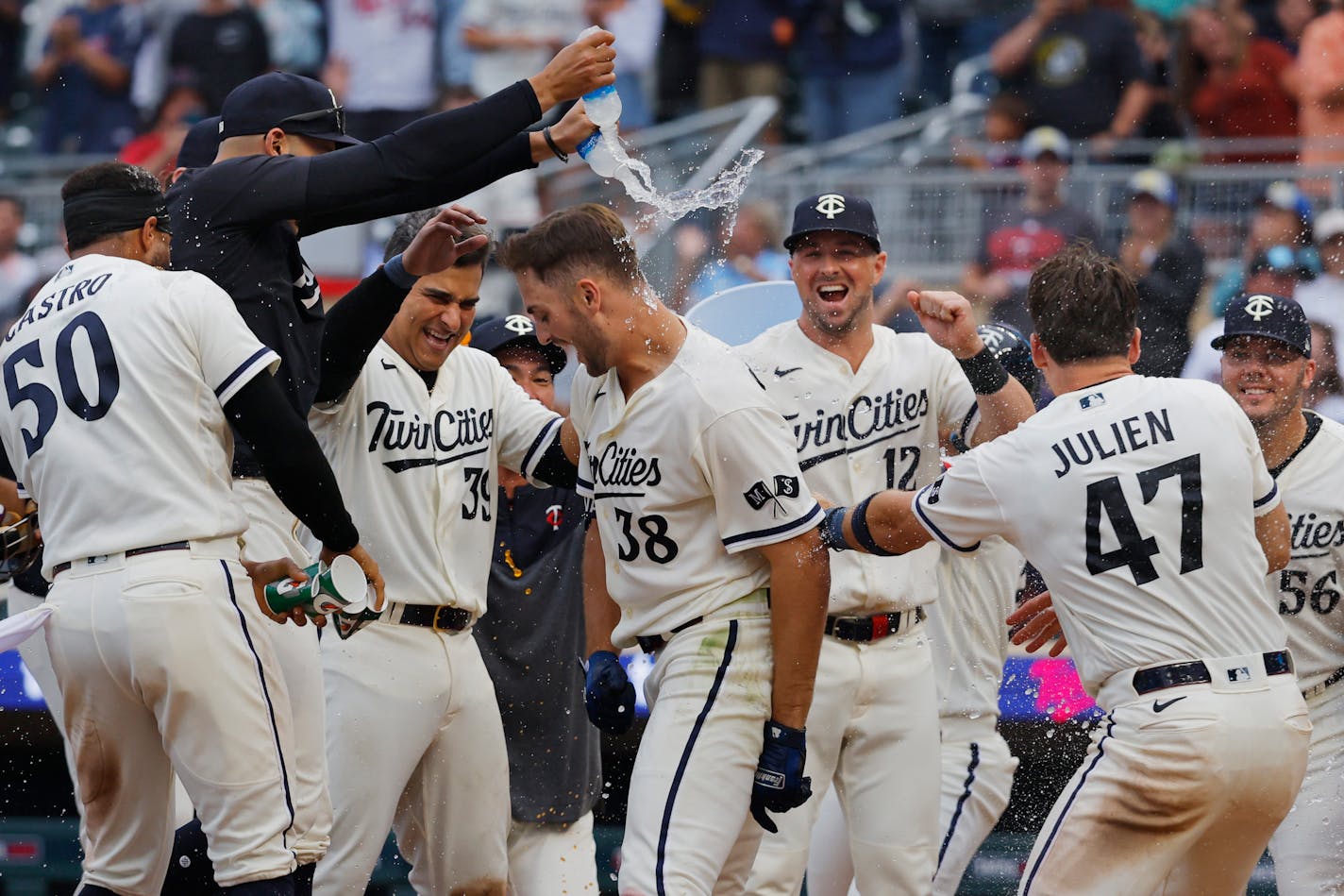 Minnesota Twins celebrate as Matt Wallner (38) scores on his two-run home run to defeat the Arizona Diamondbacks in the ninth inning of a baseball game Sunday, Aug. 6, 2023, in Minneapolis. (AP Photo/Bruce Kluckhohn)