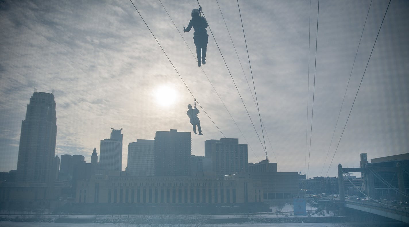 With the skyline for a view people made their way across the Mississippi River via zip line, Friday, January 26, 2018 in Minneapolis, MN. ] ELIZABETH FLORES &#xef; liz.flores@startribune.com