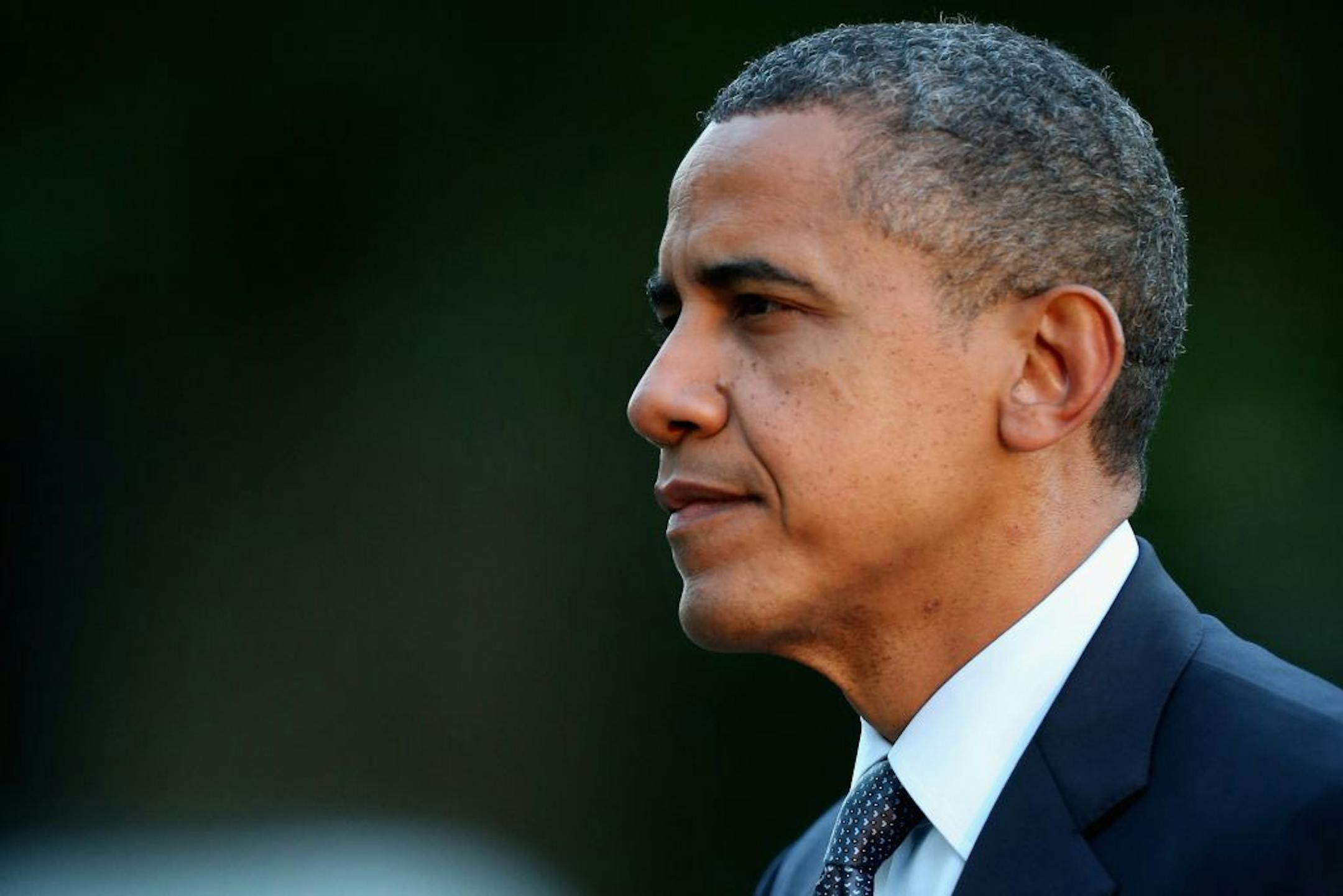 President Barack Obama waves to members of the news media after arriving at the White House Thursday, September 13, 2012 in Washington, DC. Obama returned to Washington after a two-day campaign trip to Nevada and Colorado.