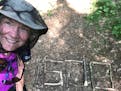 Dianne Seger, on the Appalachian Trail, marking her mileage.