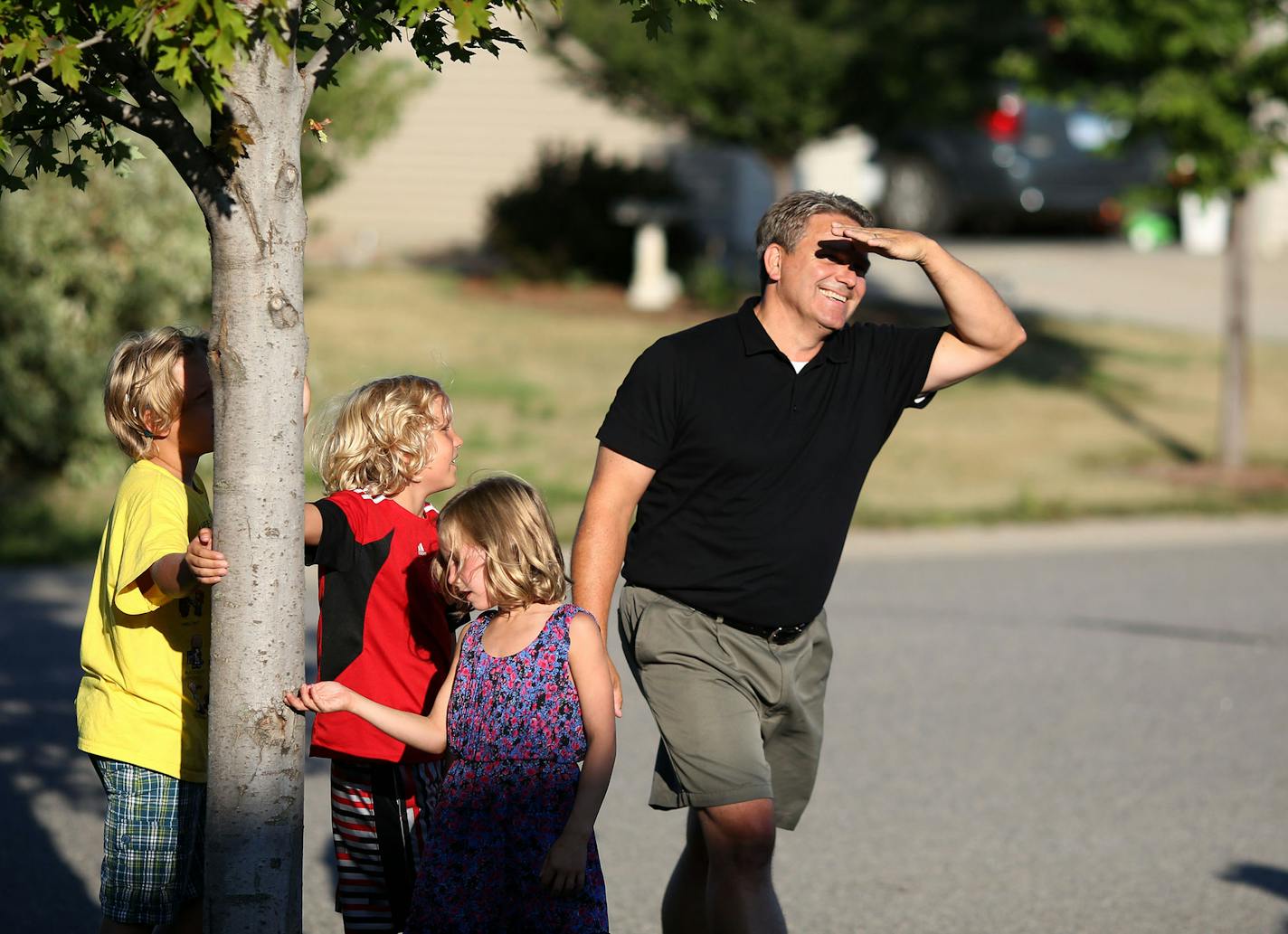 Todd Hoffner waited for his turn up at the plate as he and some neighbors played kick ball in the side yard. ] (KYNDELL HARKNESS/STAR TRIBUNE) kyndell.harkness@startribune.com At the home of Todd Hoffner, who lost his job at Minnesota State Mankato as football coach when he was accused of taking inappropriate pictures of his children on a University-issued cell phone, but later cleared an got his job back in Mankato Min. Tuesday, August, 12, 2014.