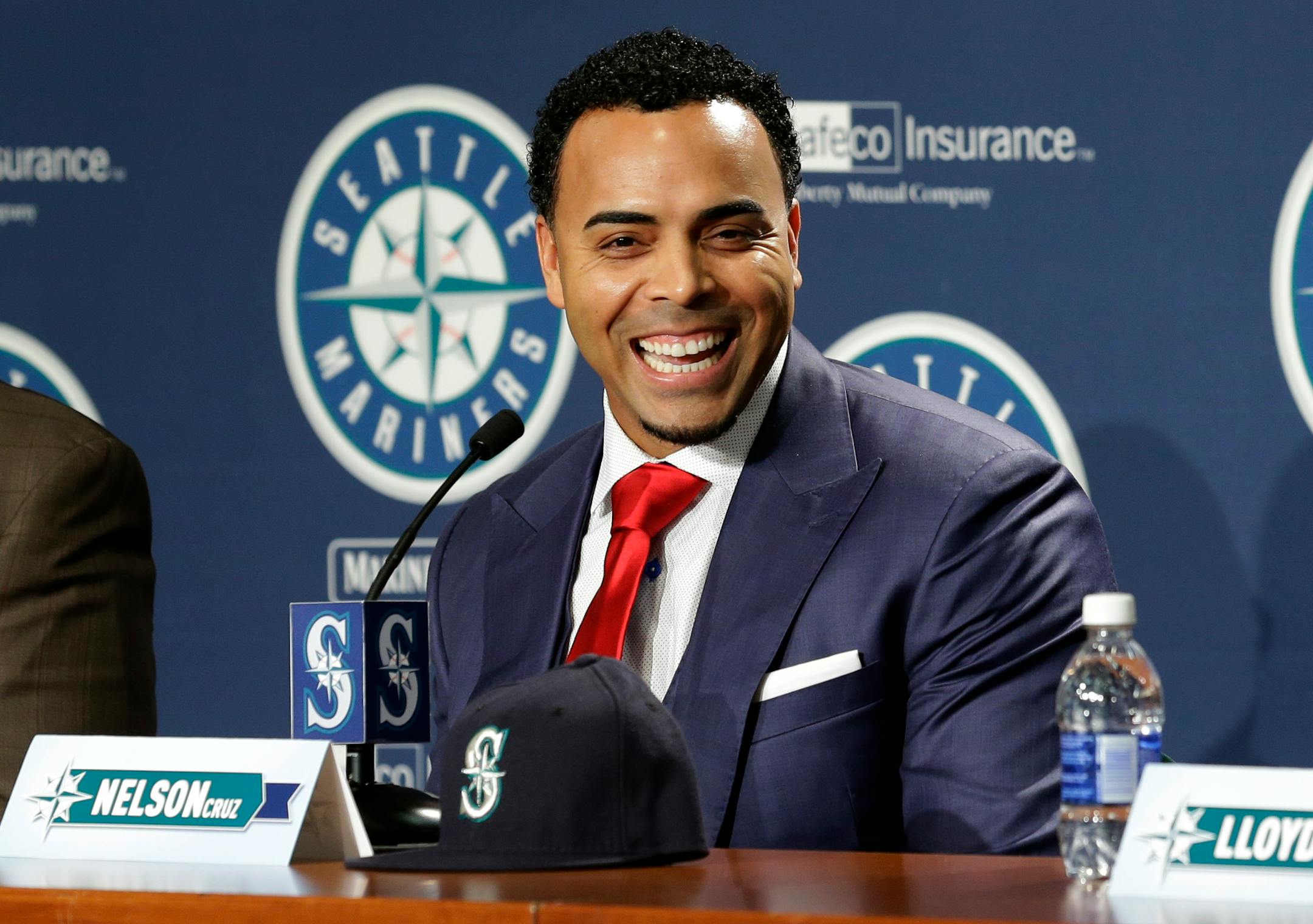 Seattle Mariners' Nelson Cruz smiles as he talks to reporters after being introduced at a baseball news conference, Thursday, Dec. 4, 2014, in Seattle. (AP Photo/Ted S. Warren)