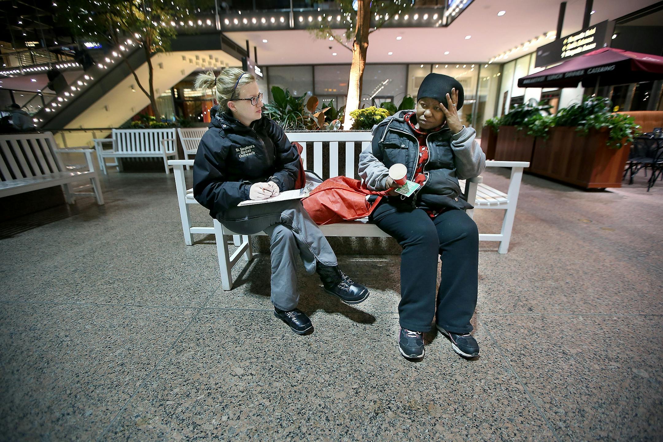 Breanna Schell, MSW, LGSW, and the Street Outreach Program Manager from St. Stephen's Human Services, left, listened to Donna as she sat in the lobby of the IDS building after spending the night on the rail system early Thursday, January 28, 2015 in Minneapolis, MN. Many of the homeless sit in places like the IDS building, the library, and the train station for the day. The St. Stephen Outreach program participated in an annual count as they scoured the city to count unsheltered homeless people.