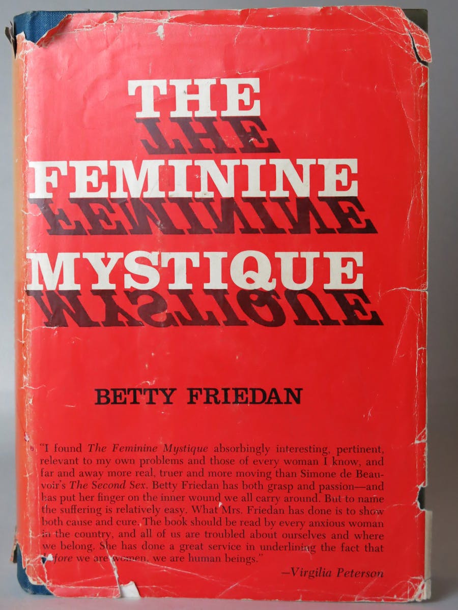 copy of ( well-worn) book by Betty Friedan " The Feminine Mystique " a 1960's landmark of feminism
