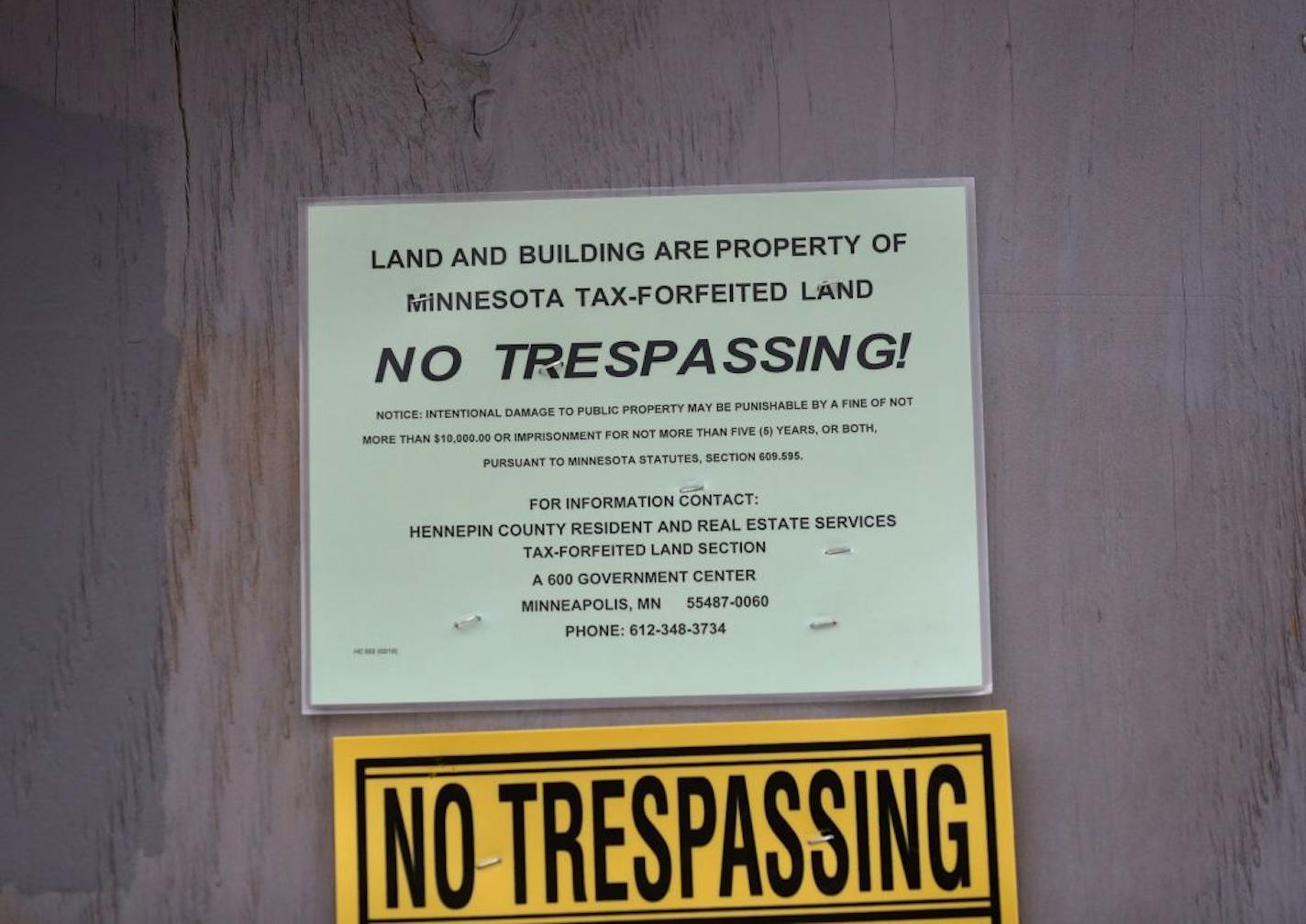 Signs on a boarded up property on the 900 block of Oliver Ave. N. Friday, March 30, 2018, in Minneapolis, MN. Vacant lots are one of several interlocking problems the Northside is dealing with as the city starts taking public comments on a draft comprehensive plan that the city claims will promote racial equality and affordable housing.