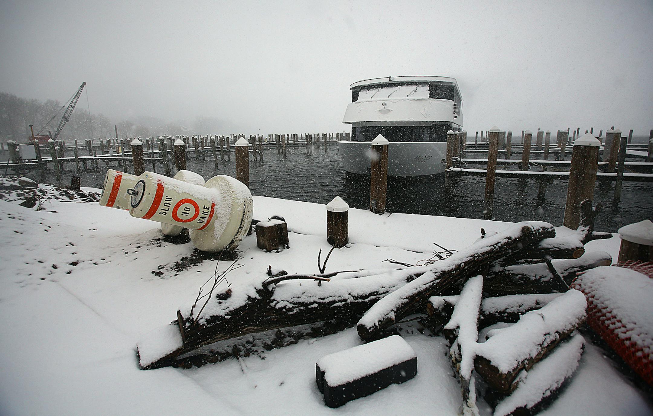 Snow fell atop docks and the shoreline at Tonka Bay Marina, where late-season ice on Lake Minnetonka has delayed many activities, including recreational boating, until warmer weather prevails. Last year the ice went out on the lake on March 21. This year several events have already been postponed, including the annual Lions Club crappie contest, which had been scheduled for this Saturday (April 20). ] (JIM GEHRZ/STAR TRIBUNE) / April 18, 2013 / 2:00 PM Tonka Bay, MN