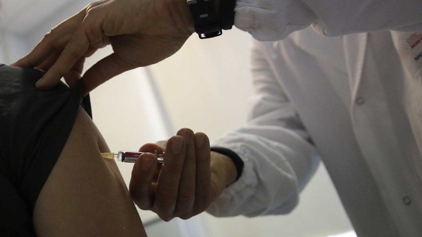 In this photo taken on Friday, Feb. 23, 2018 Doctor Roberto Ieraci vaccinates a woman in Rome. The nation is battling one of its worst epidemics of measles in recent years, reporting a six-fold increase in cases last year that accounted for a quarter of all the cases in Europe. And yet the Italian government's response, a new law requiring parents to vaccinate their kids against measles and nine other childhood diseases, has become one of the most divisive issues going into the nation&#xed;s Mar