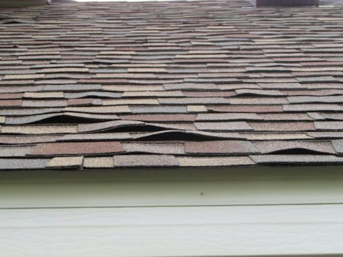 These shingles were badly buckled, and they're not going to sit flat over time.